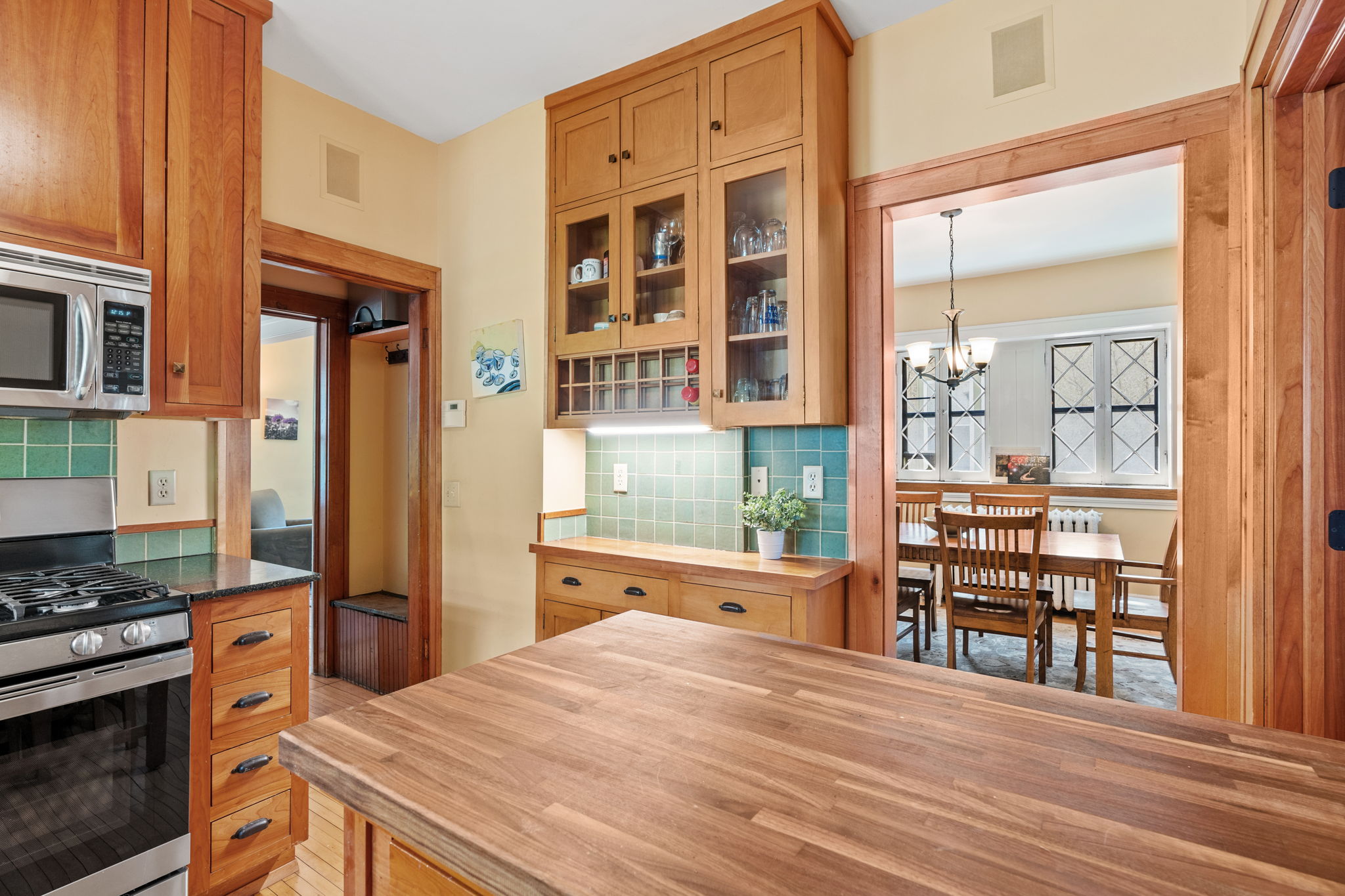 A warm and inviting kitchen with wooden cabinetry and an adjacent dining area.