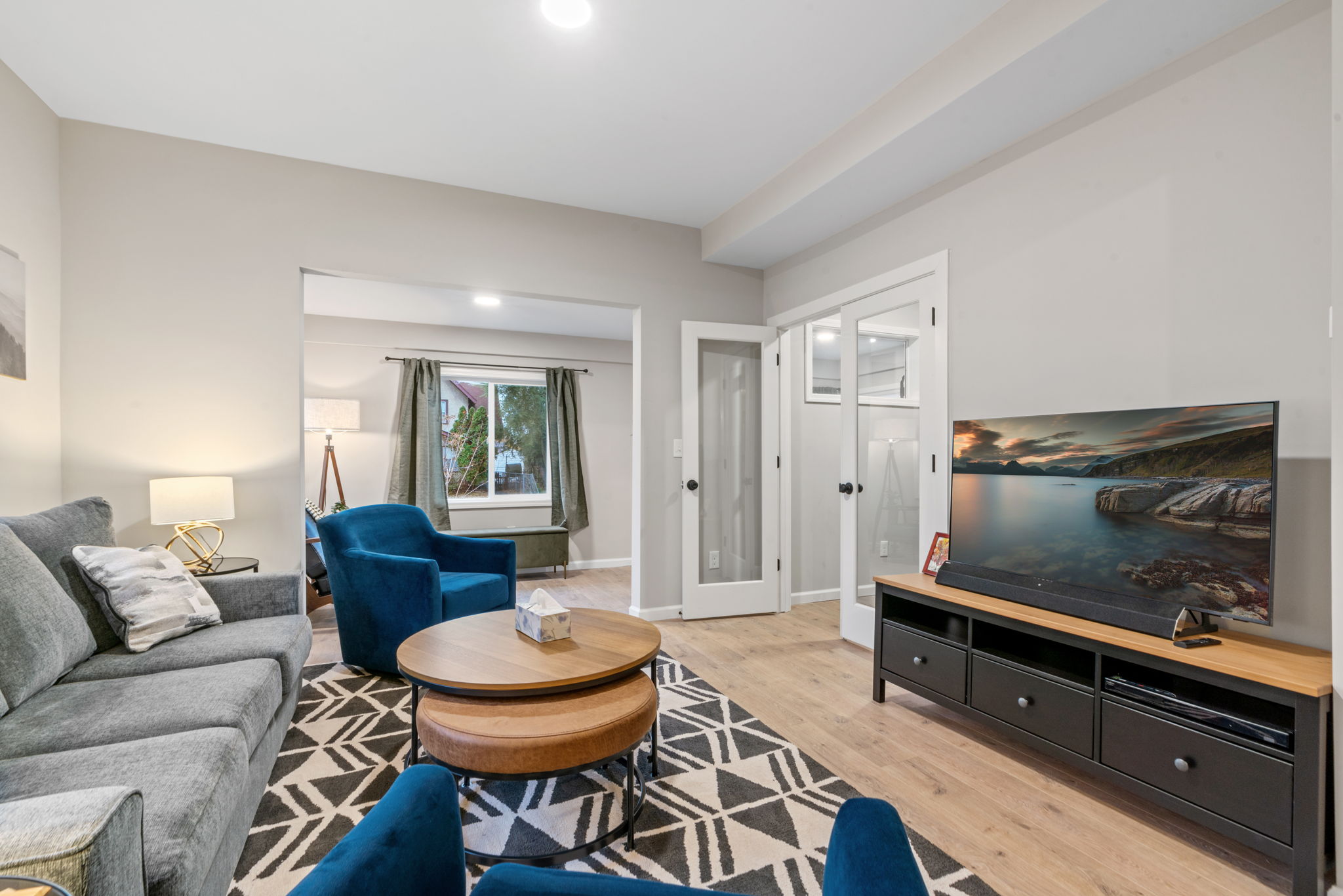 A cozy and modern living room with vibrant accents and natural light.