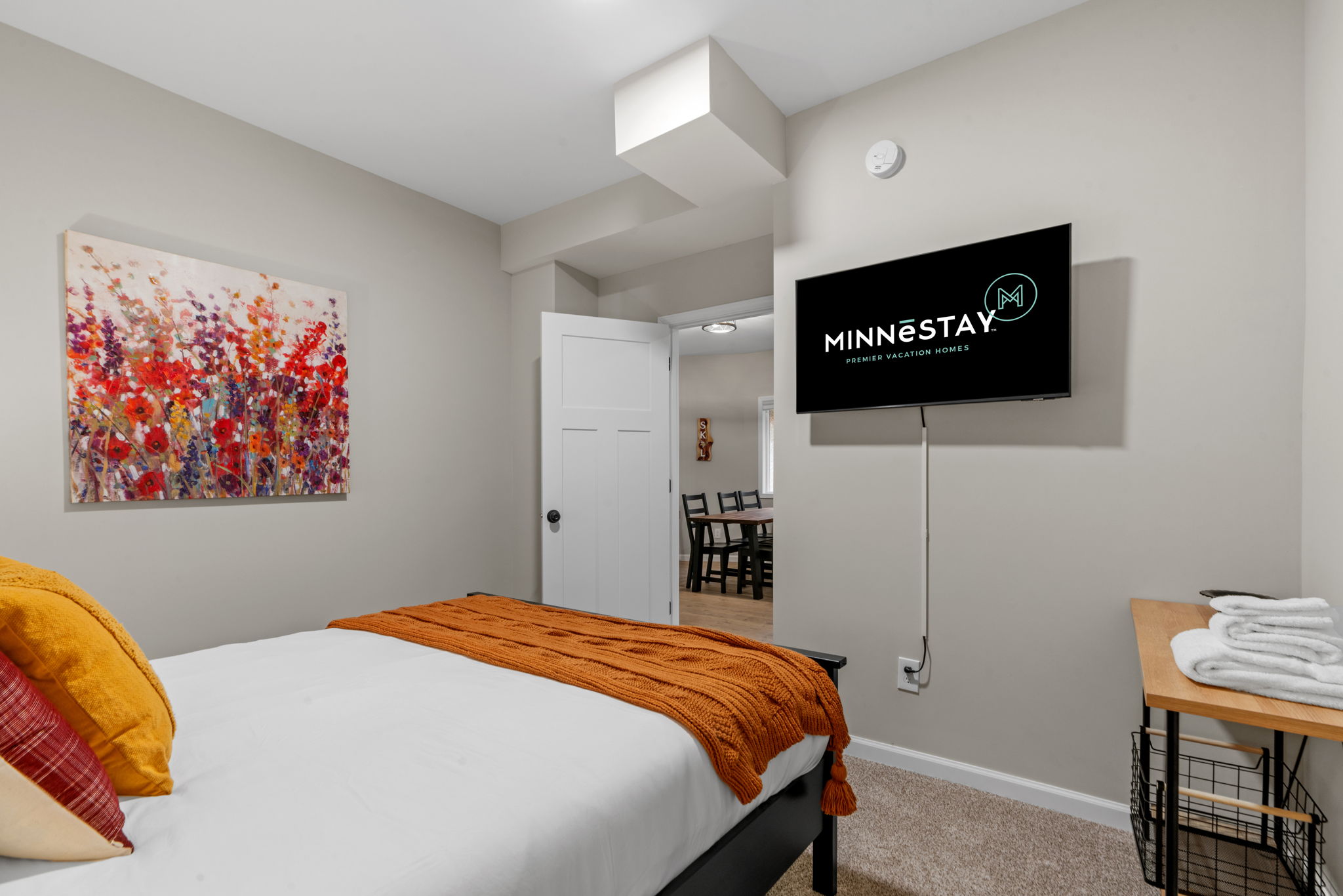 A cozy and modern bedroom with vibrant decor and a warm ambiance.