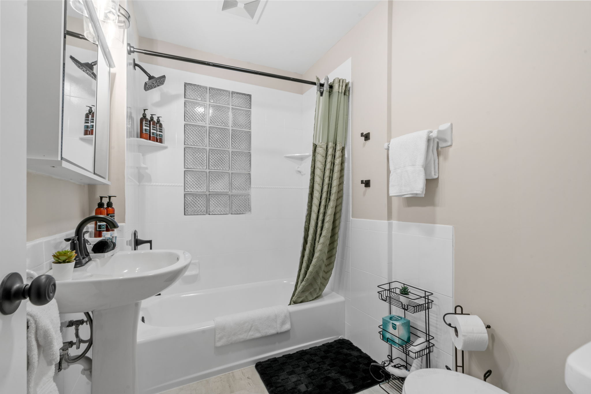 A modern and serene bathroom with stylish amenities.