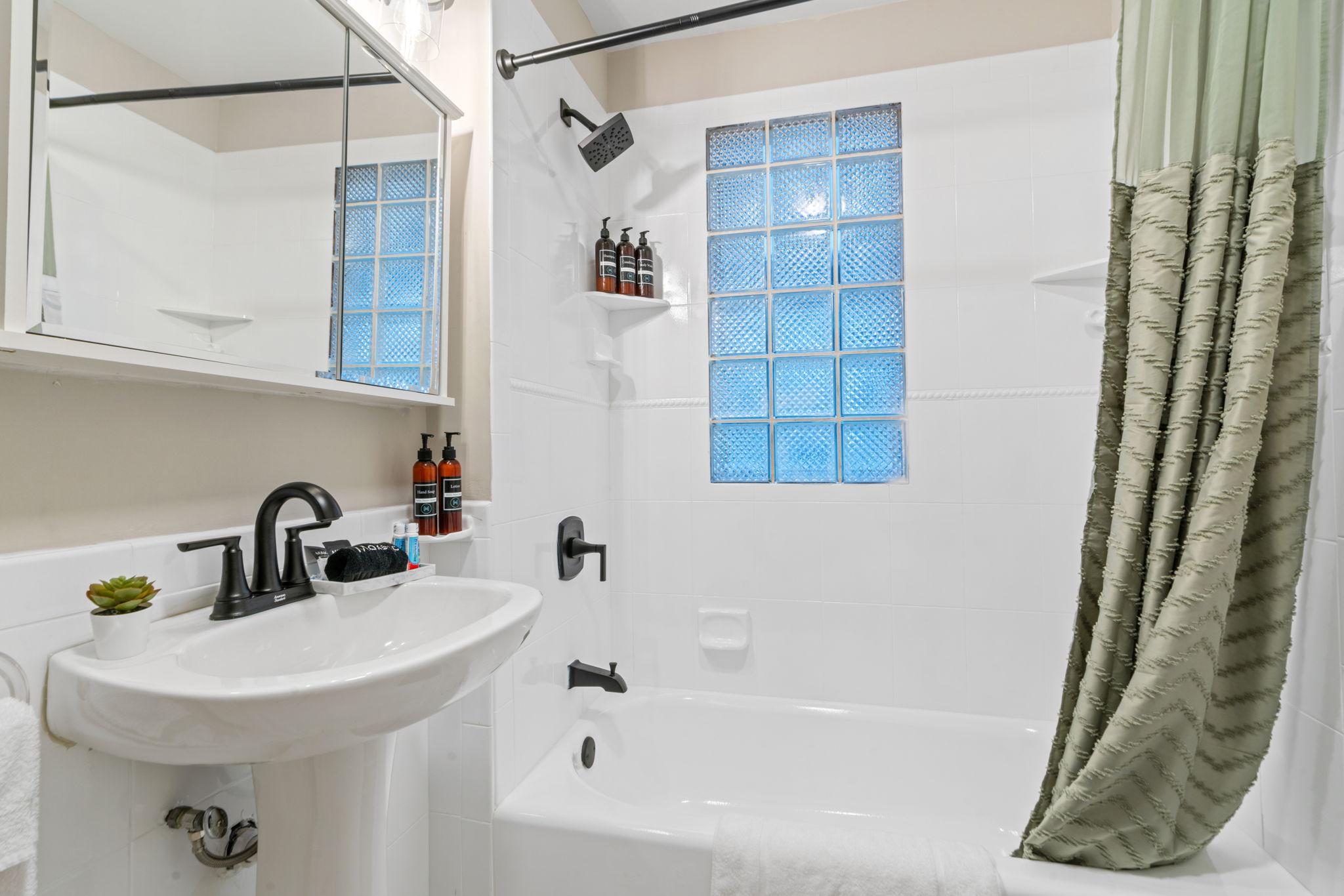 A modern bathroom with elegant fixtures and a serene color palette.