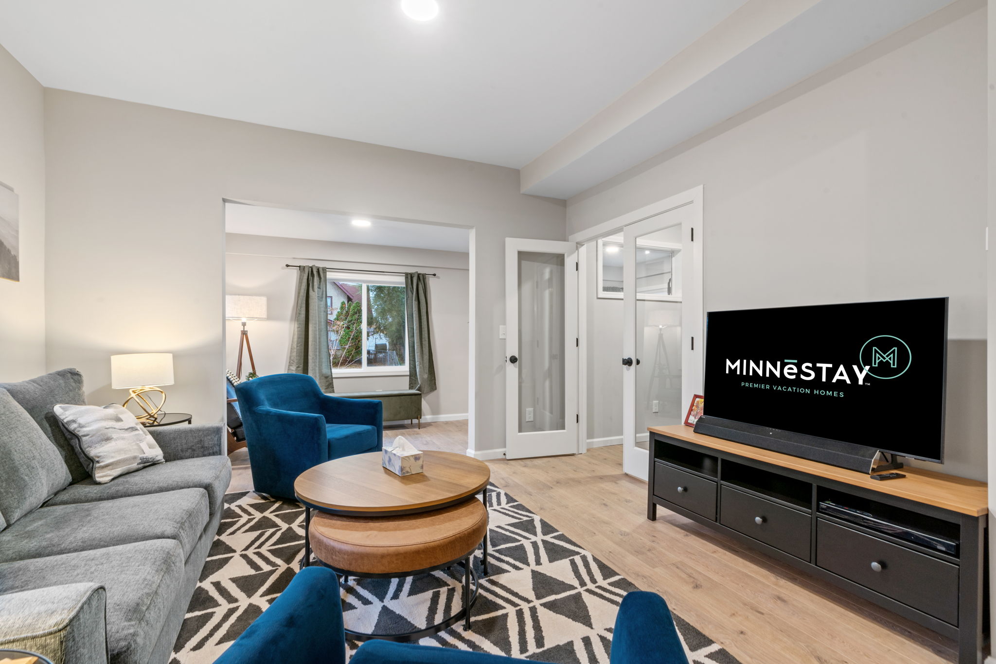 A modern living room featuring stylish furnishings and ample natural light.