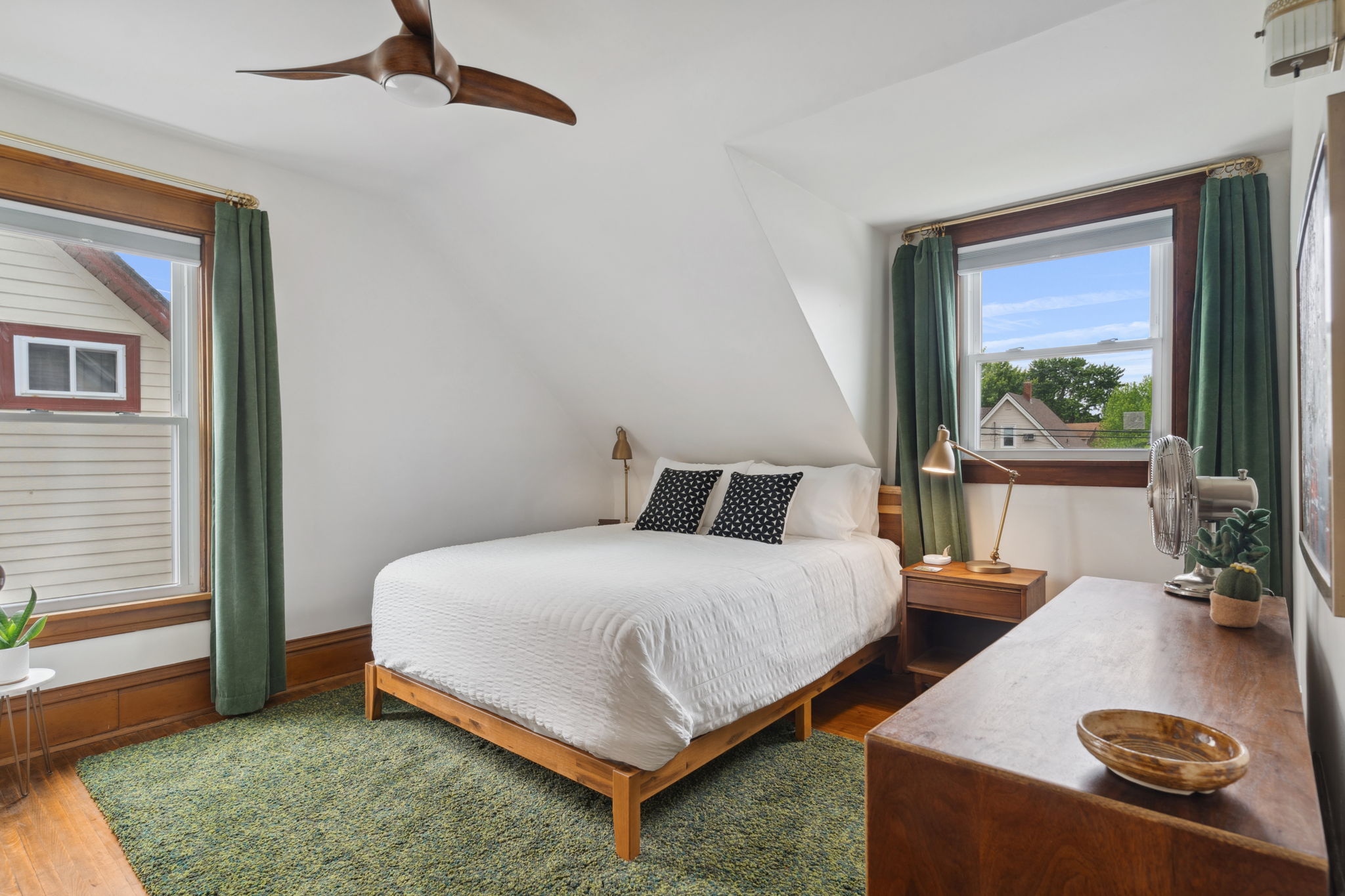 A serene and modern bedroom with natural accents and cozy furnishings.