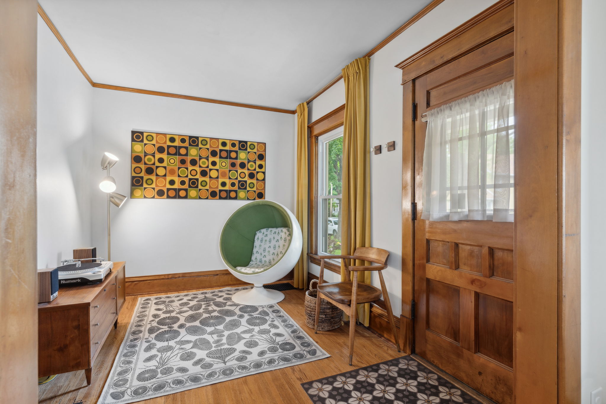 A cozy corner featuring a modern egg chair and vintage decor.