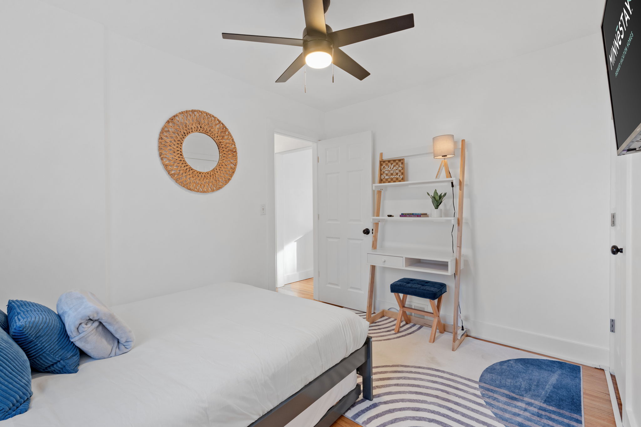 A bright and minimalist bedroom featuring a cozy bed and stylish decor.