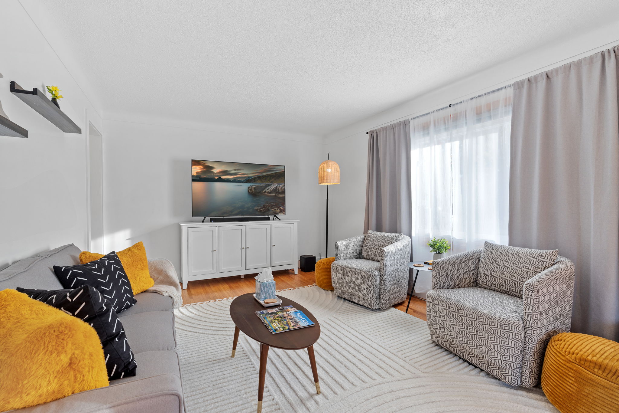 A modern living room with a cozy atmosphere, featuring contemporary furniture and warm accents.