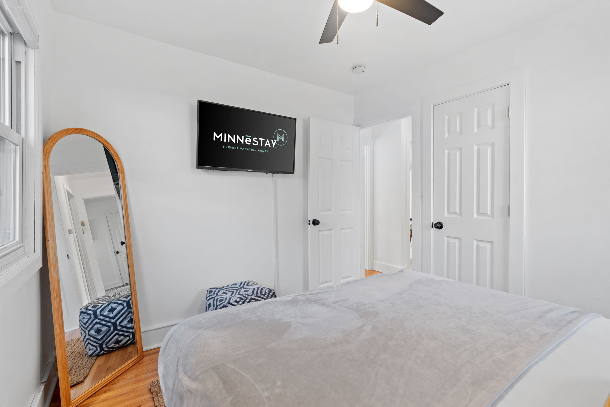 A bright and modern bedroom featuring a cozy bed and contemporary decor.