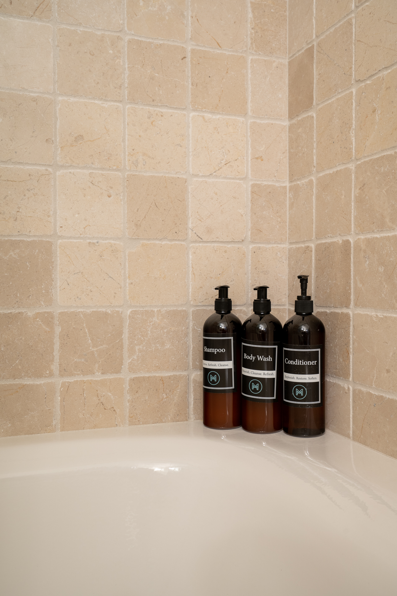 Stylish bath products in a serene shower corner.
