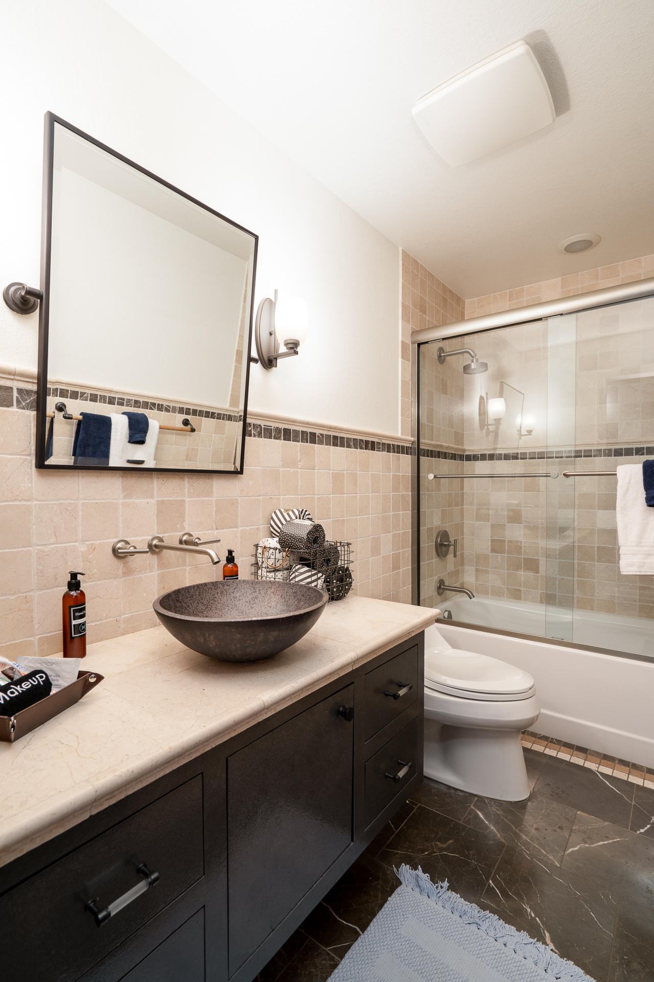 A modern and minimalist bathroom featuring a luxurious round sink and stylish decor.