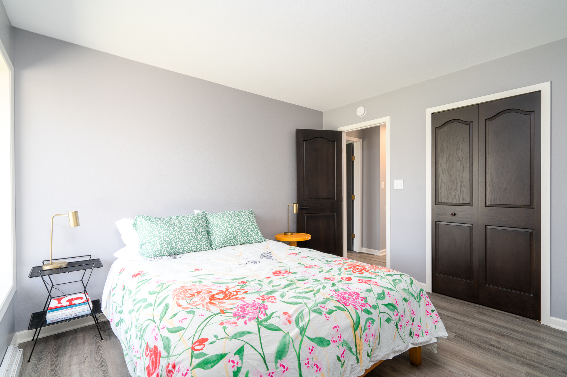 A bright modern bedroom with floral decor and elegant furnishings.