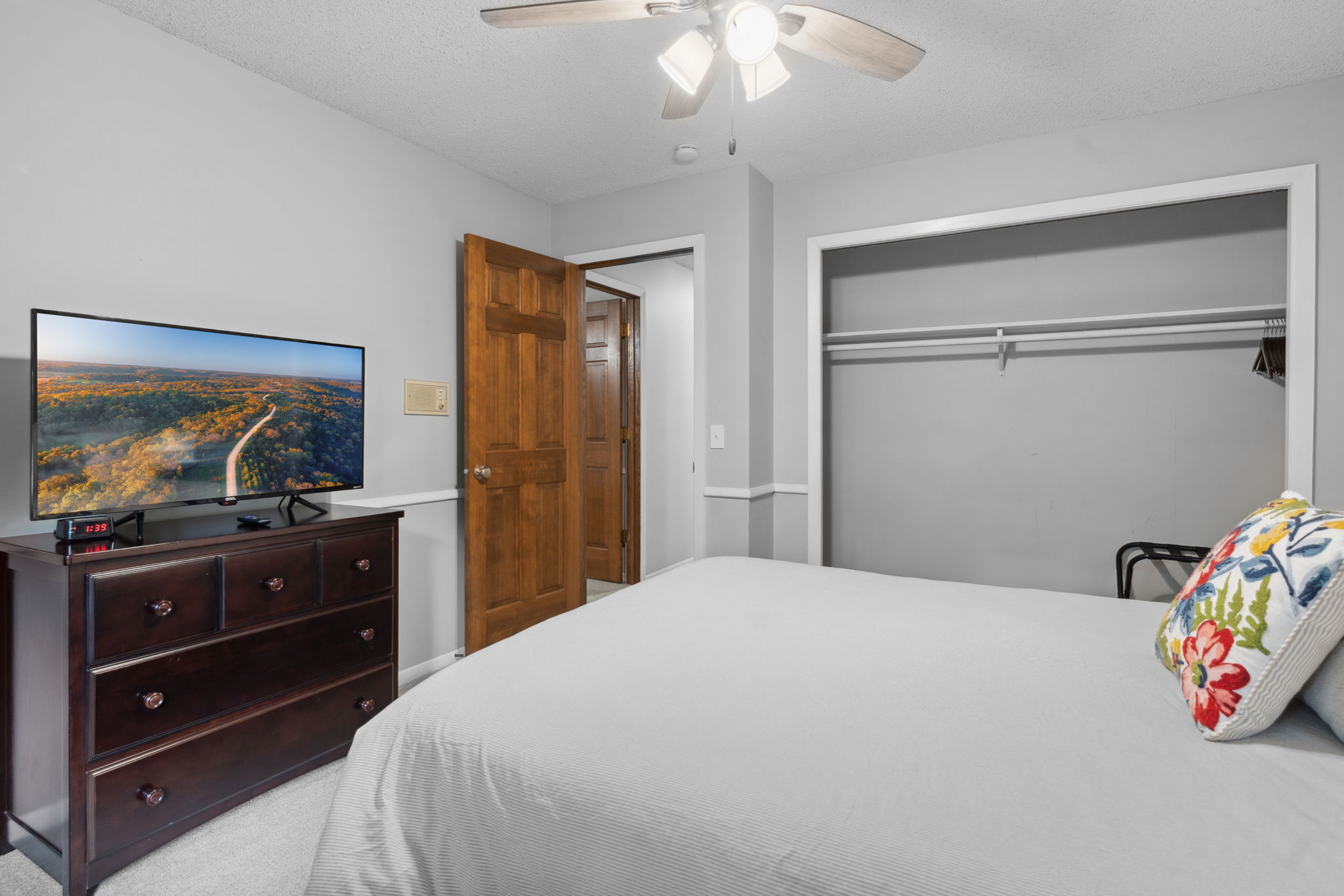 A cozy bedroom featuring modern amenities and warm decor.