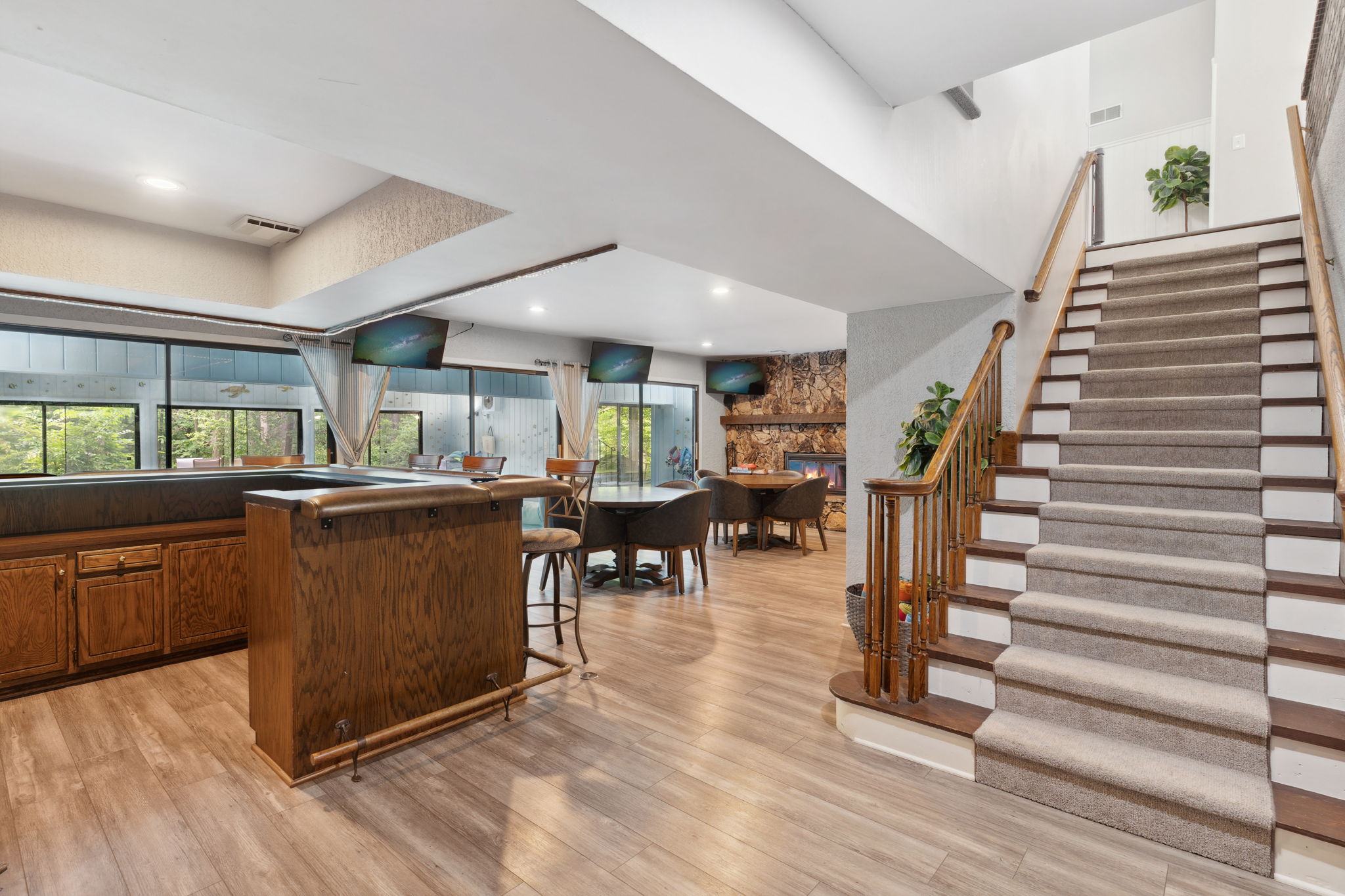 Inviting living space featuring a bar, dining area, and cozy fireplace.