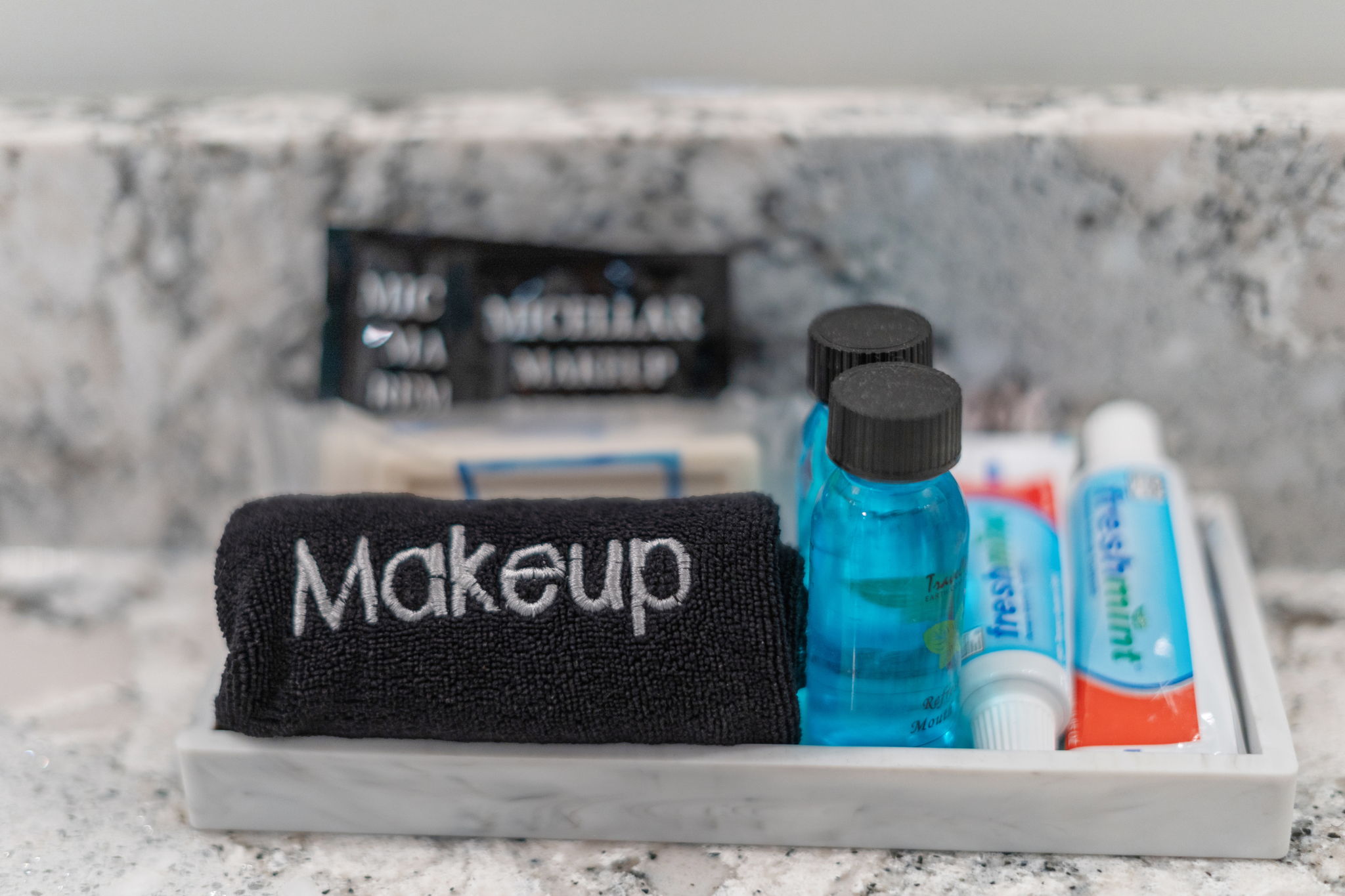 A bathroom tray featuring skincare and oral hygiene essentials.