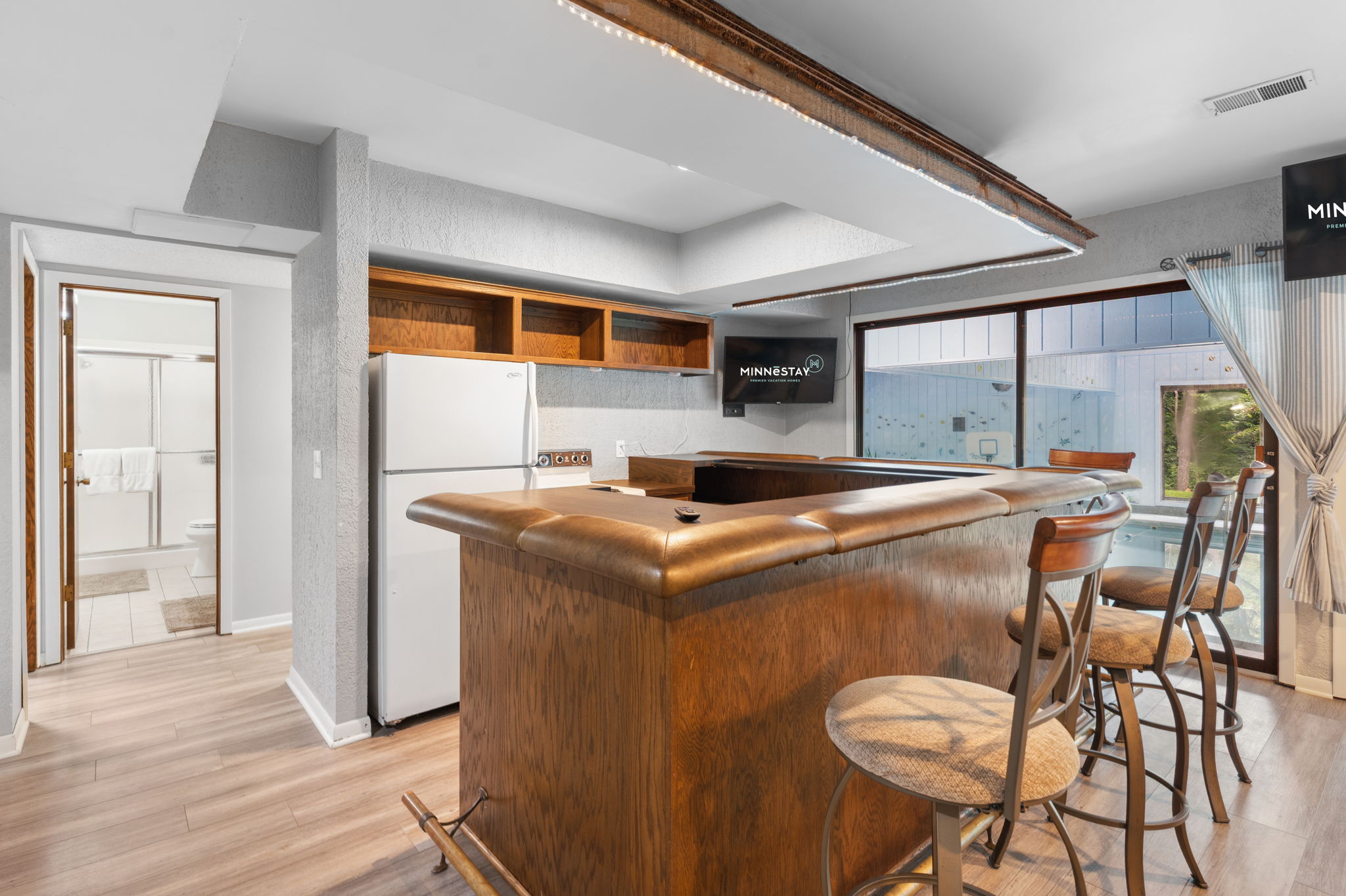 Cozy kitchen space with a bar area and outdoor views.