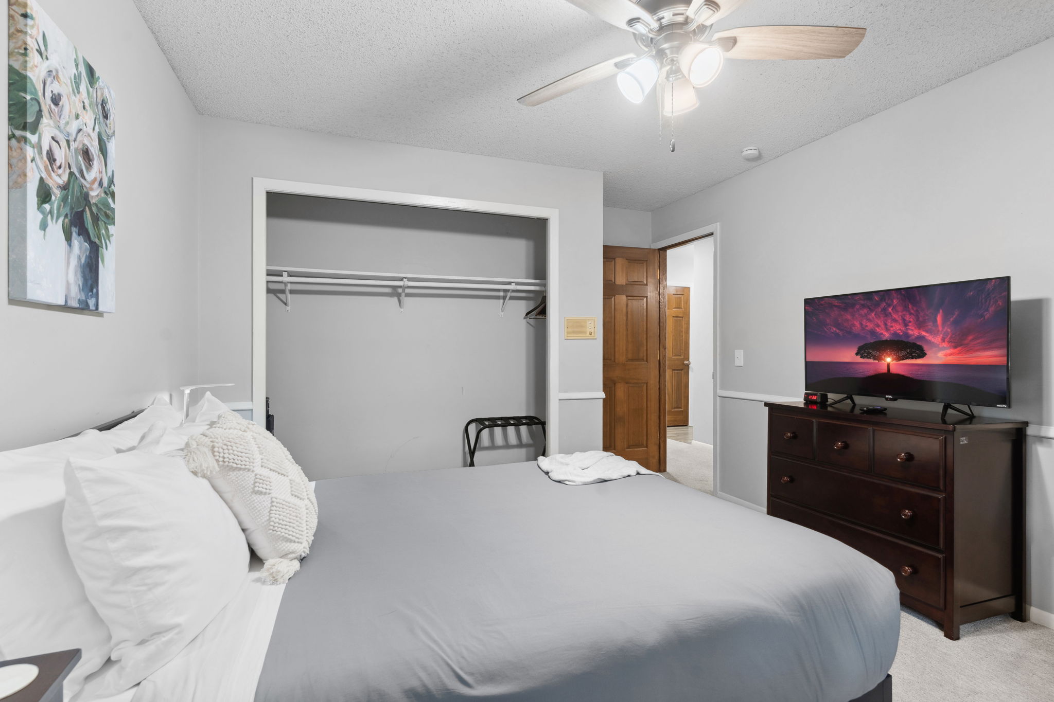 A cozy bedroom featuring a queen-sized bed, elegant decor, and modern amenities.