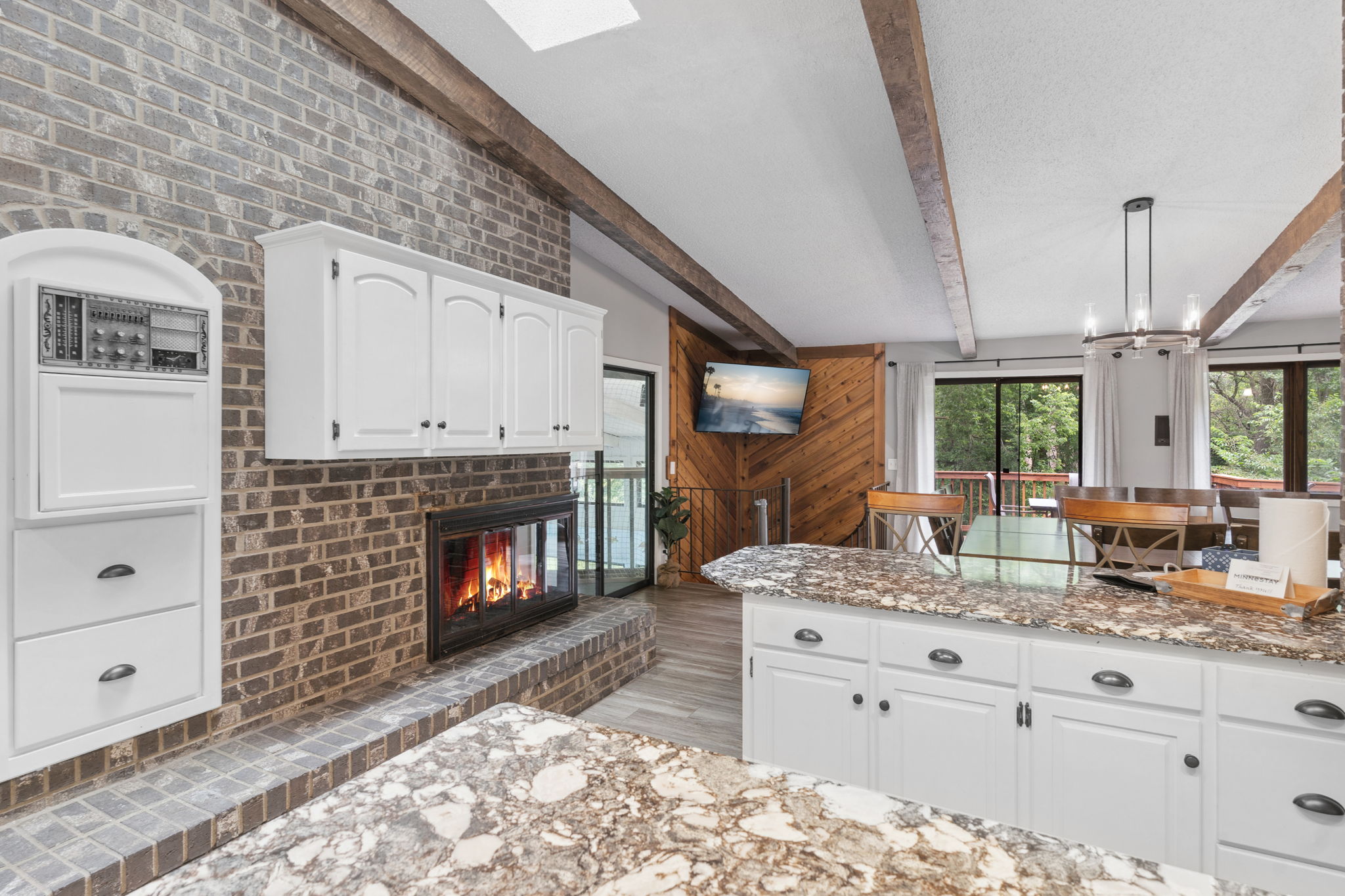 A beautifully designed kitchen and dining space with a cozy fireplace and modern features.
