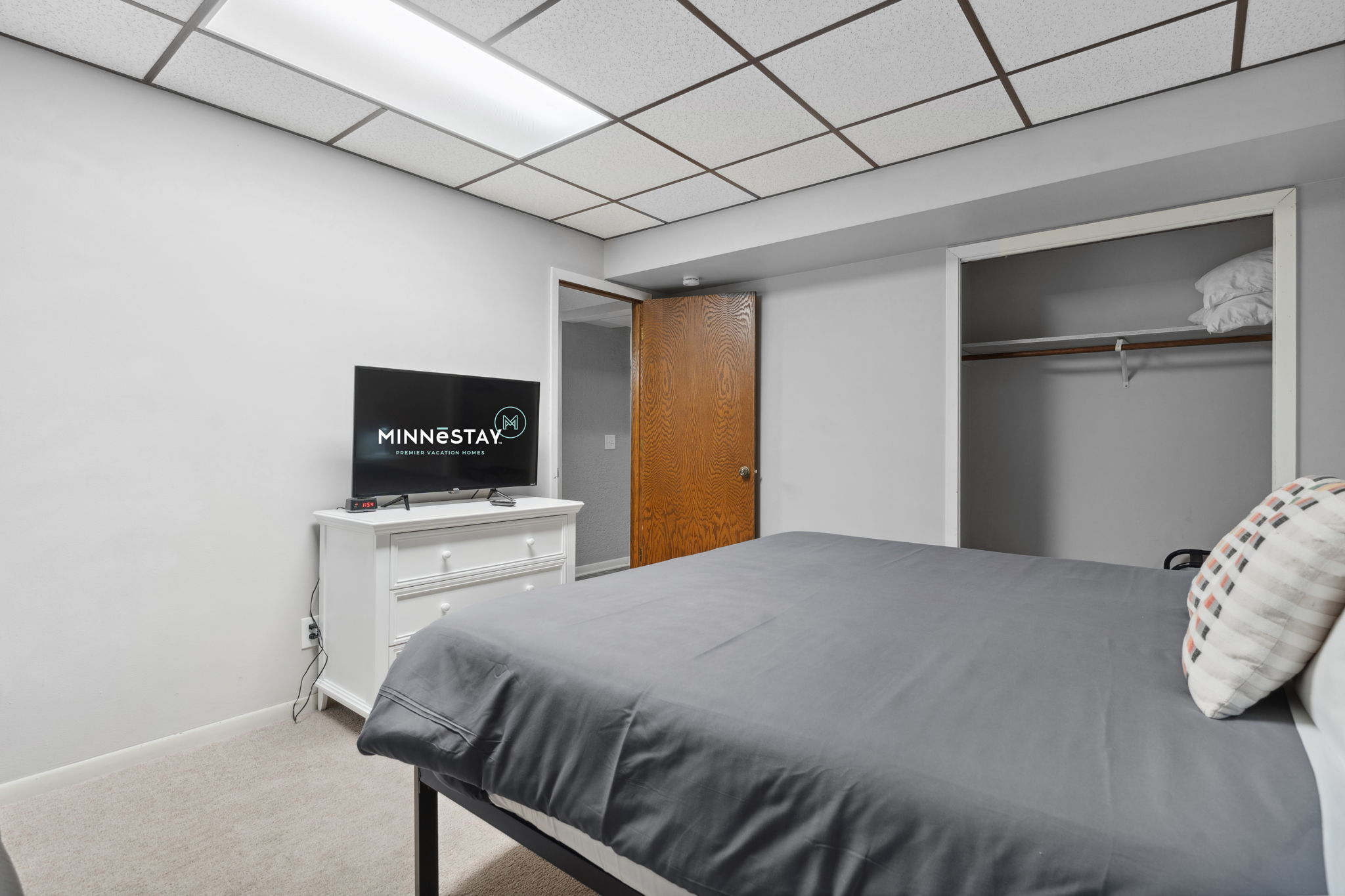 A cozy bedroom with modern amenities and a welcoming atmosphere.