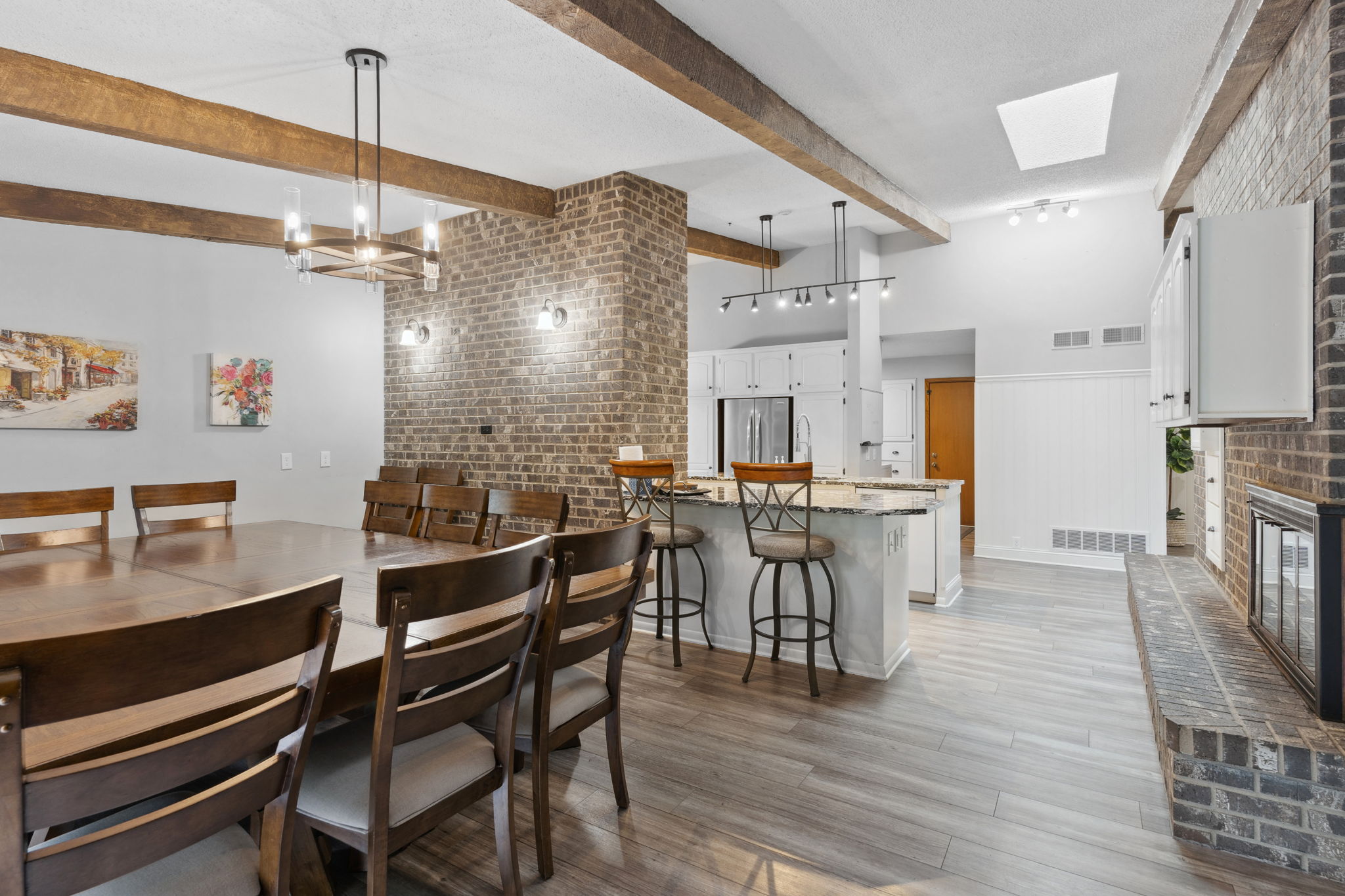 Stylish open-concept dining and kitchen area with rustic charm.