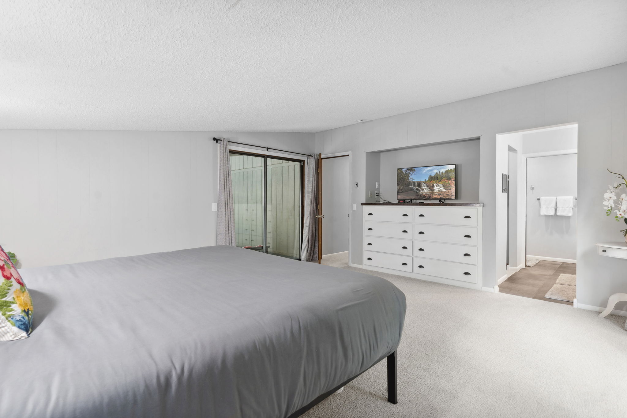 A serene and spacious bedroom with modern decor.