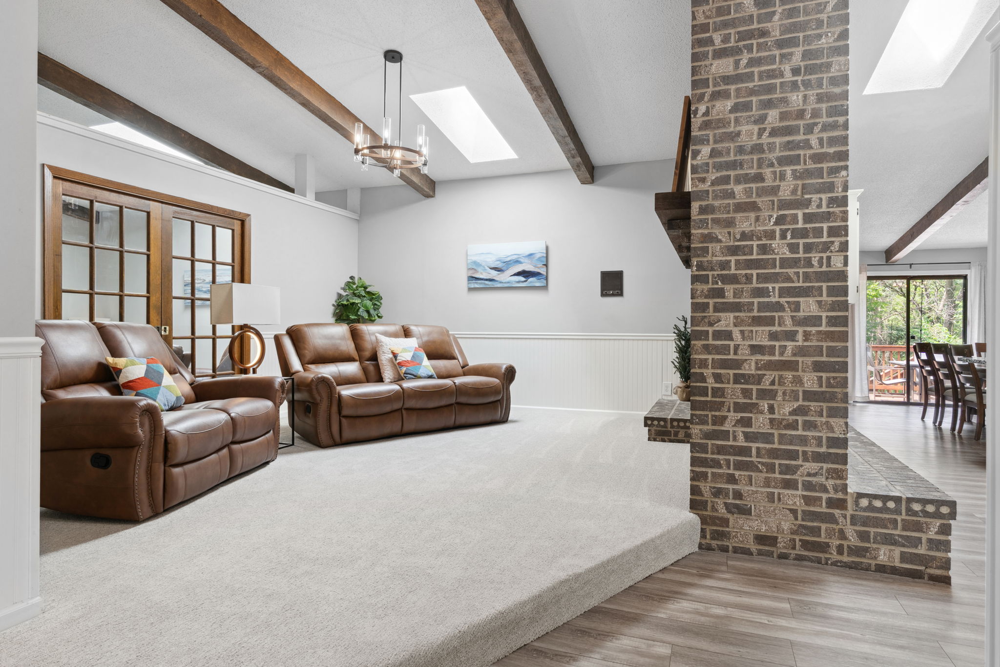 A cozy living room with leather recliners and modern decor.