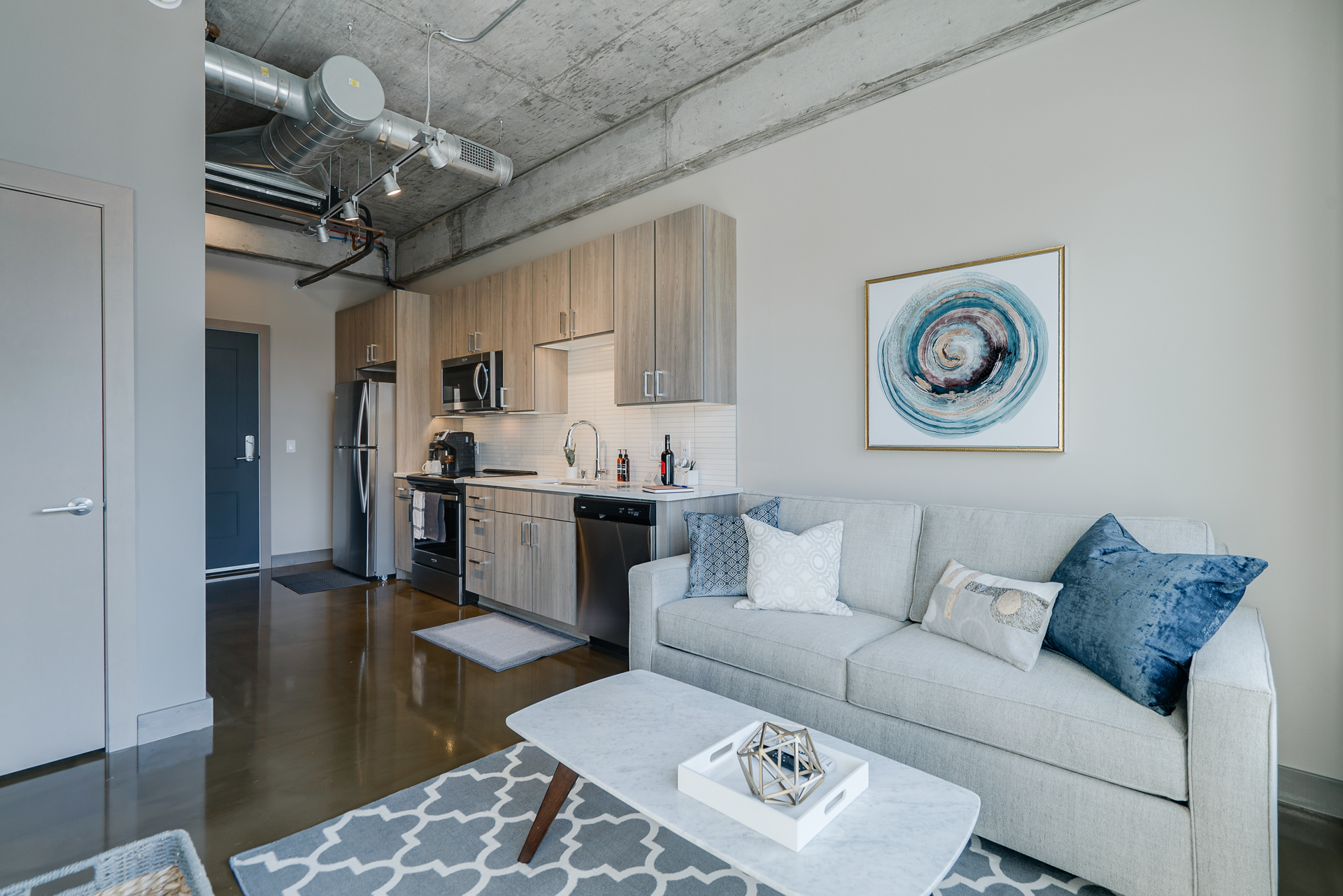 Modern apartment interior with open kitchen and living room.