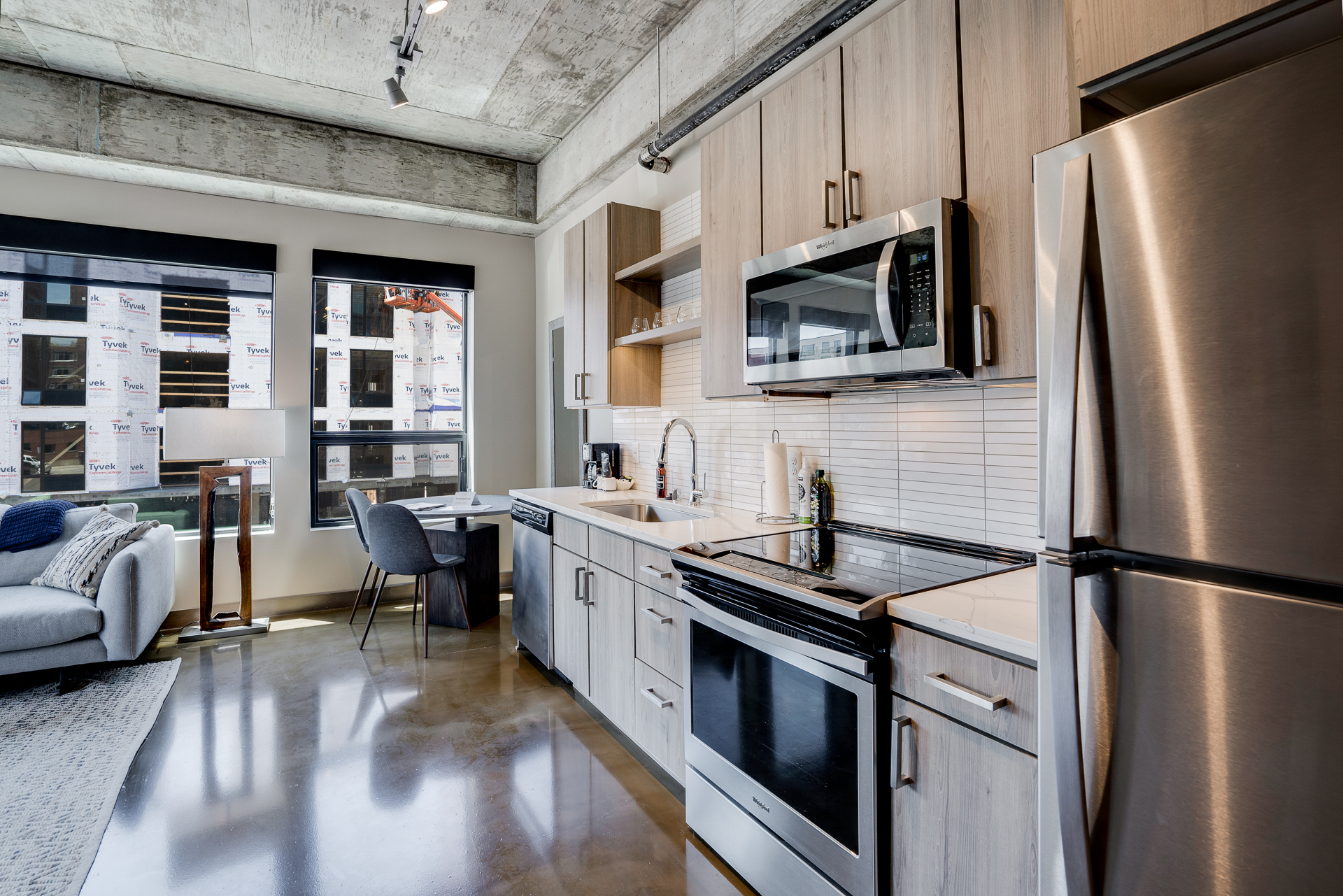 A sleek, modern kitchen combined with a cozy living area perfect for urban living.