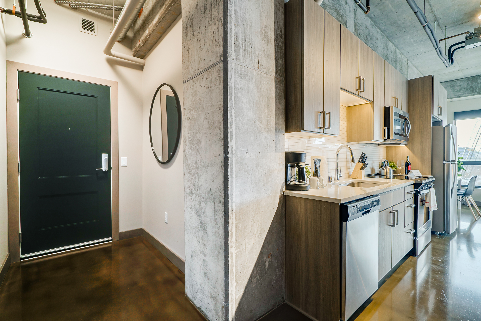 A modern kitchen with sleek cabinetry and a contemporary entryway.