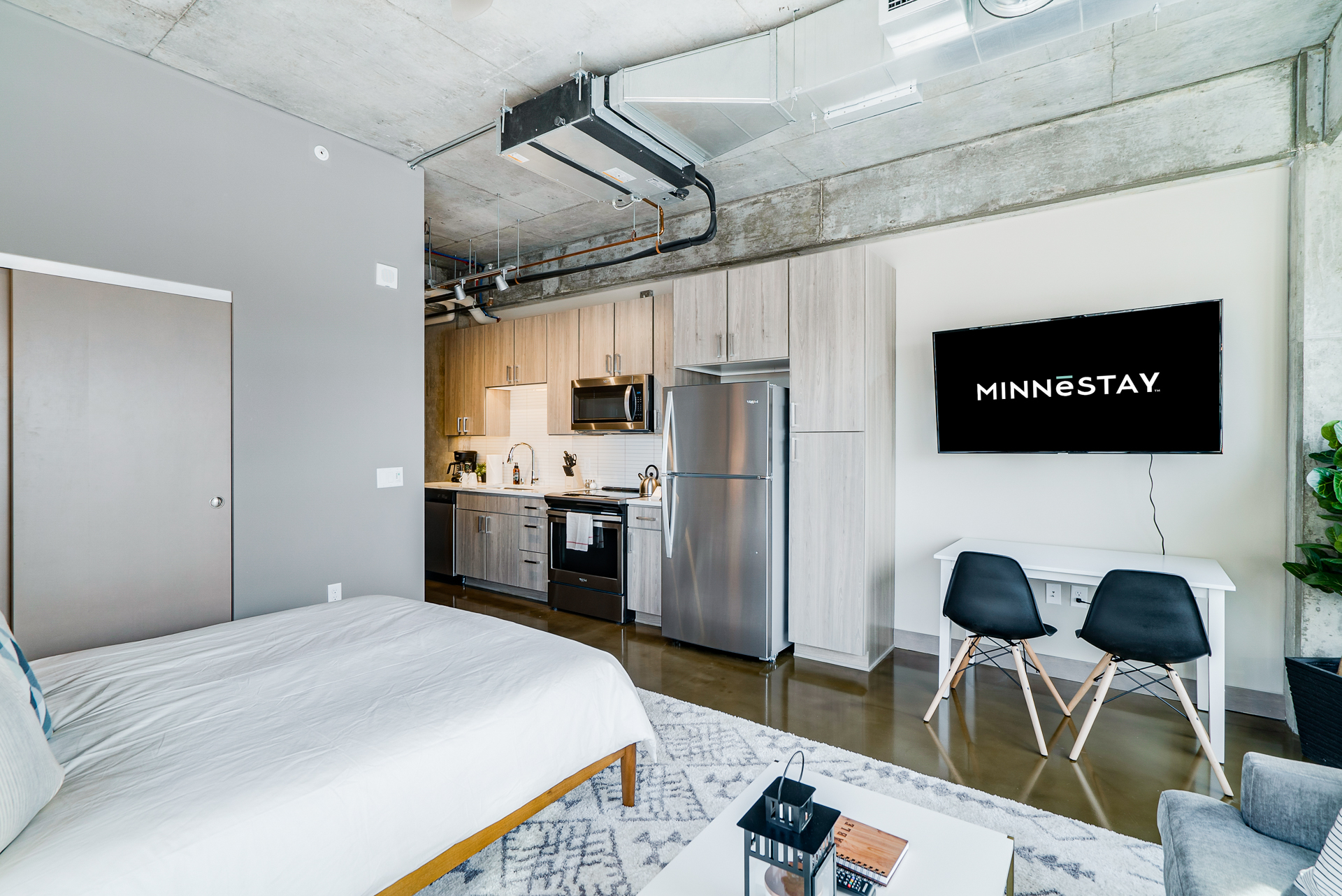 Spacious modern studio featuring industrial design elements and contemporary furnishings.