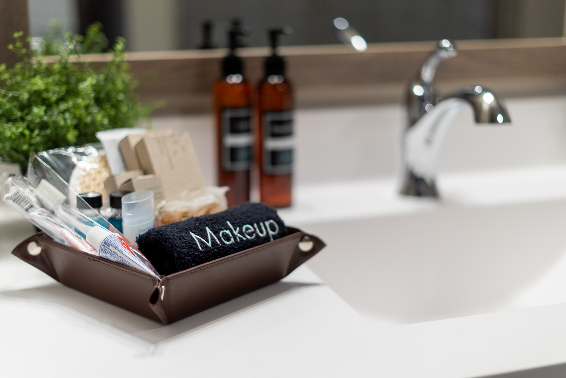 Organized toiletries and makeup essentials in a stylish bathroom setup.