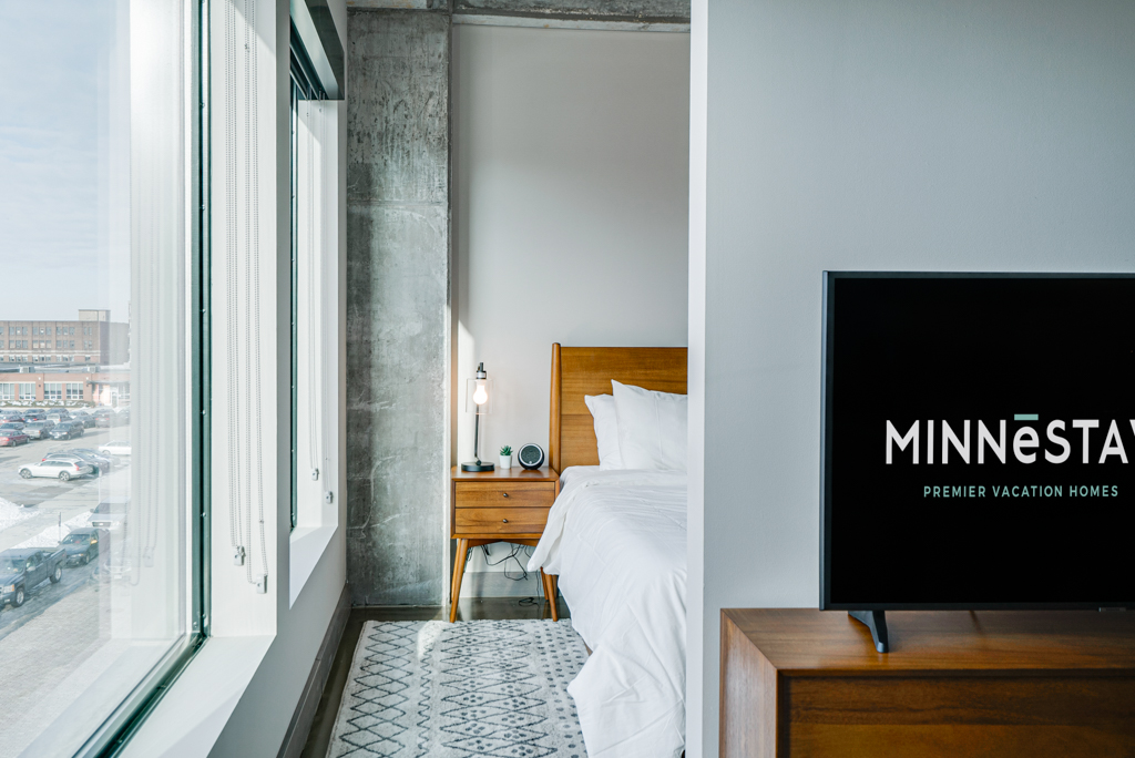 Modern bedroom with a view and minimalist decor.