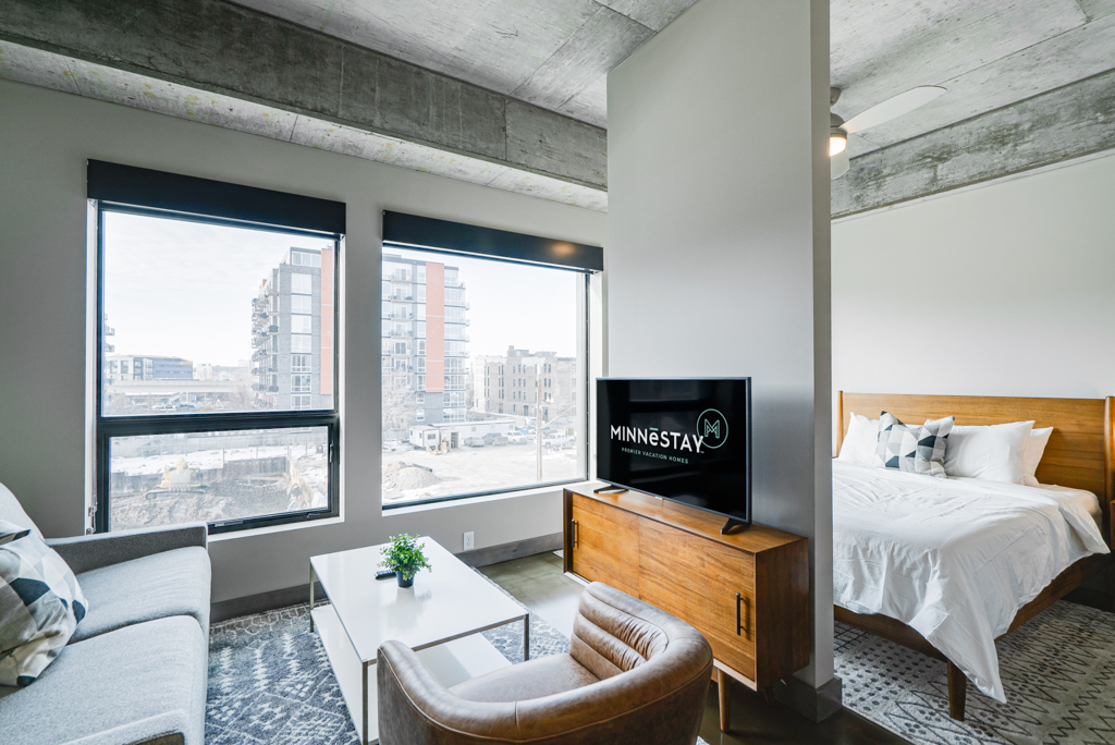 Stylish studio apartment with urban views and modern decor.