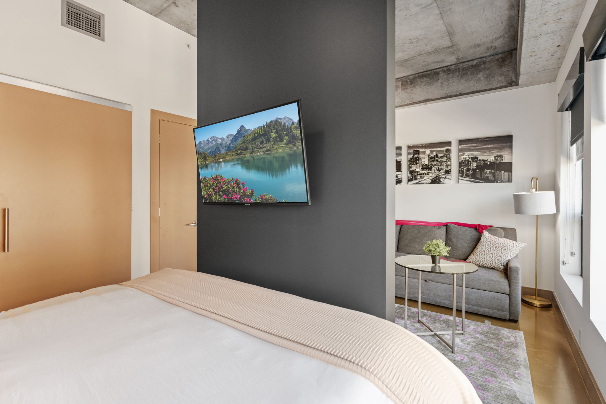 Modern bedroom and living area featuring a sleek design and cozy vibes.