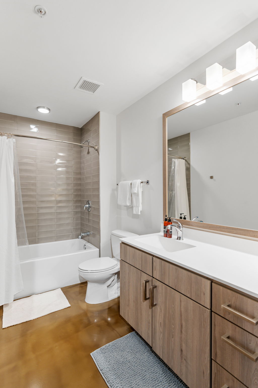 A modern bathroom featuring minimalist design and neutral tones.