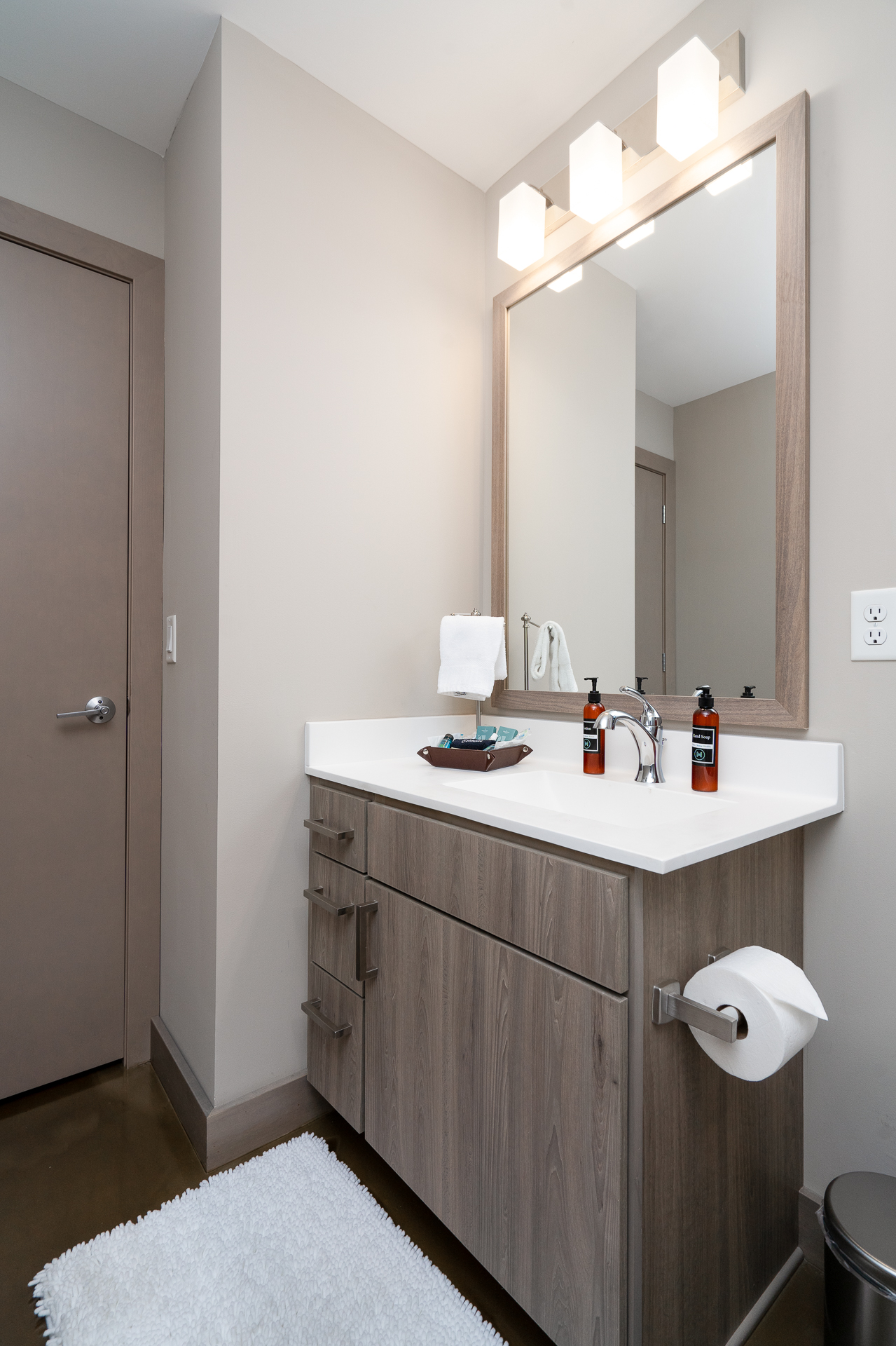 A modern bathroom with a sleek vanity, stylish fixtures, and a clean design.