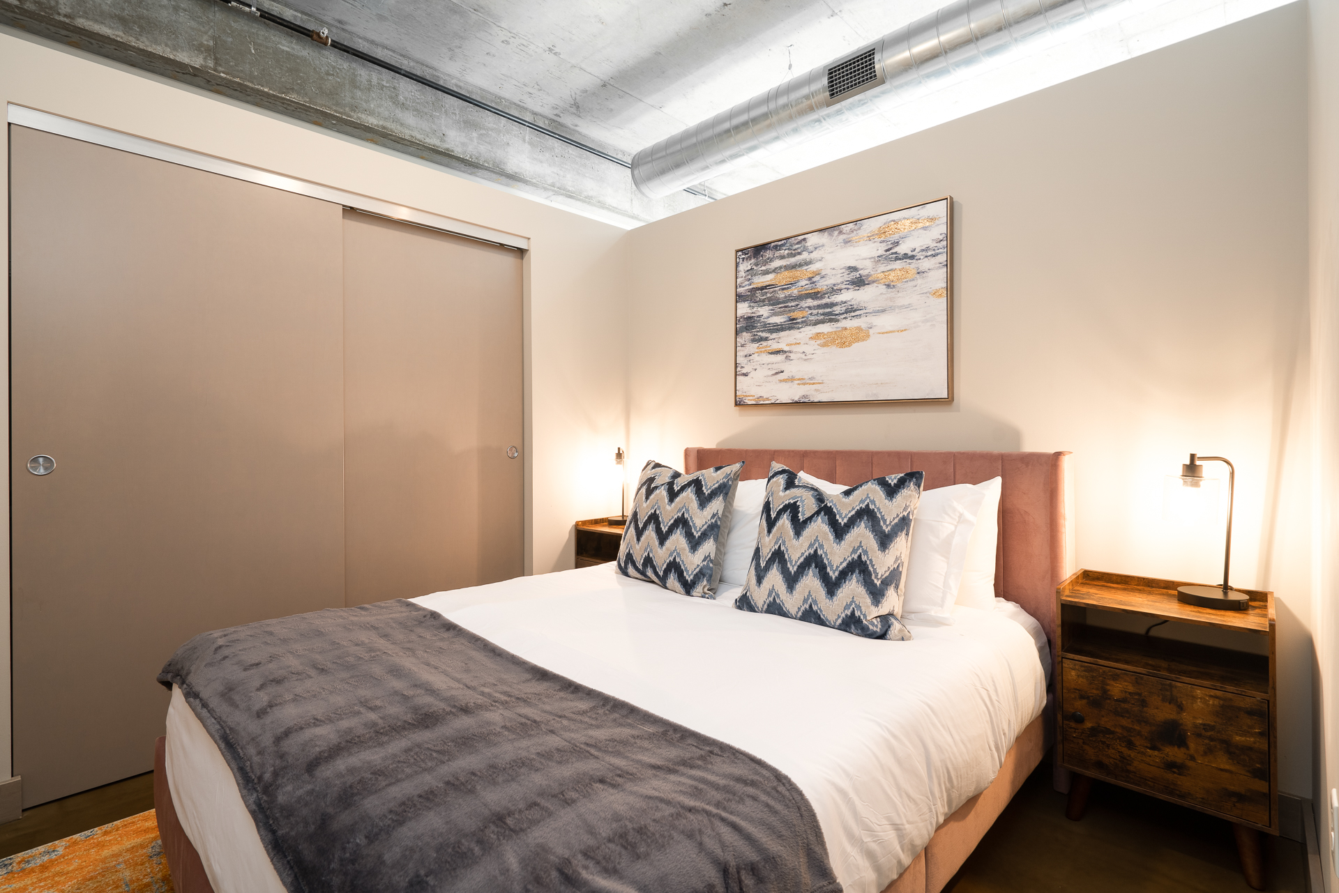 A modern and inviting bedroom featuring a plush bed and chic decor.