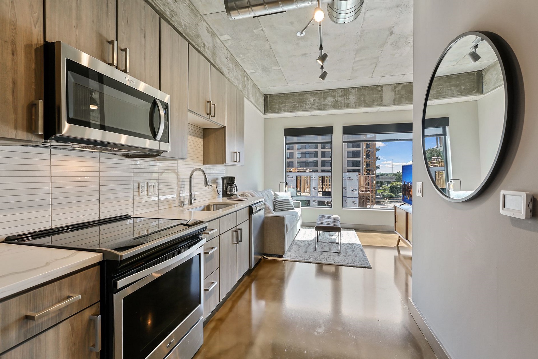 Modern apartment kitchen and living space with city views.