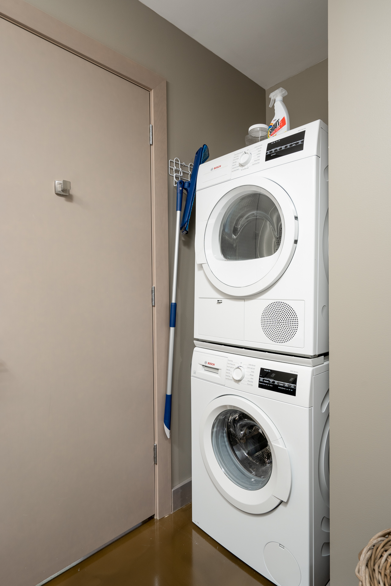 Modern laundry nook with stacked washer and dryer.
