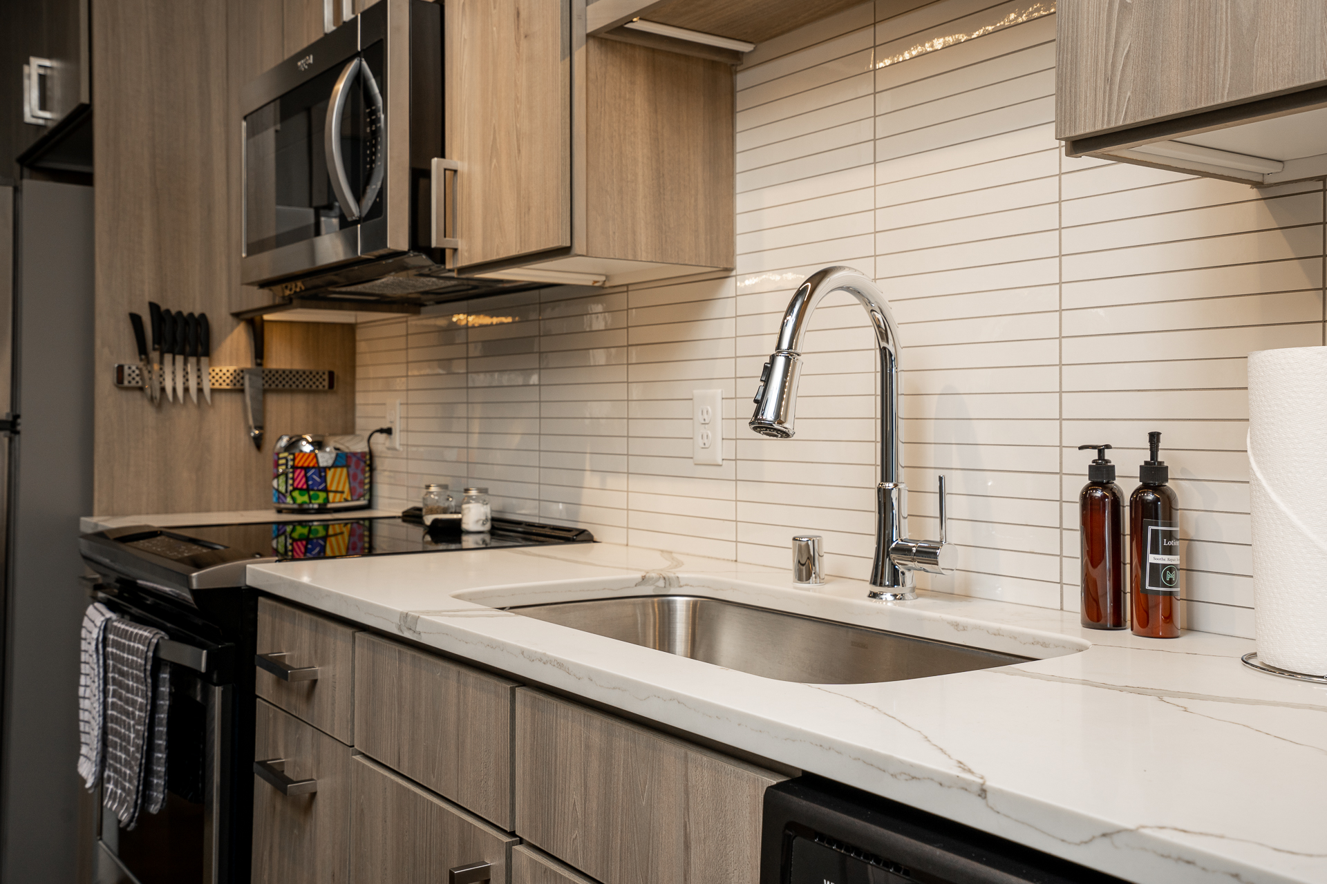 A modern kitchen with stylish wooden cabinetry and a sleek countertop.