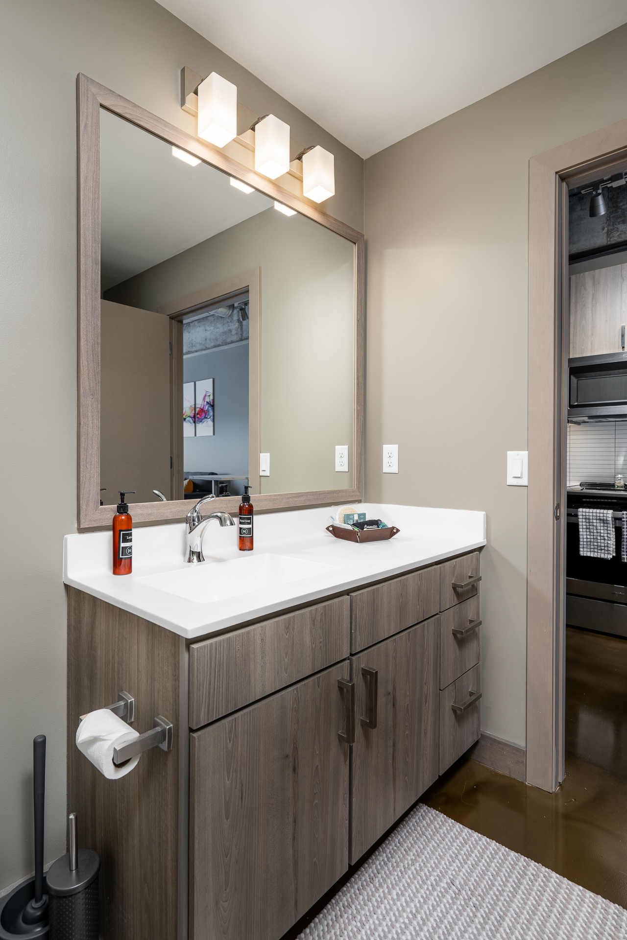A modern bathroom with a sleek vanity and stylish lighting.