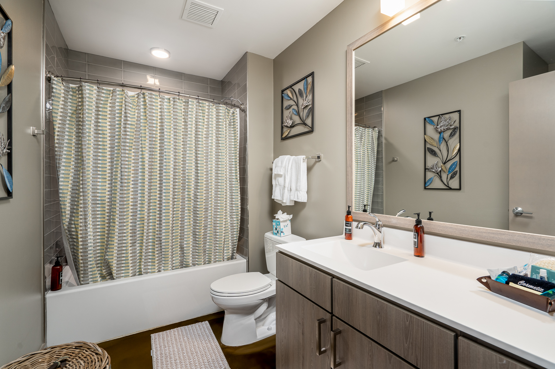 A sleek and modern bathroom with a stylish shower curtain and contemporary decor.