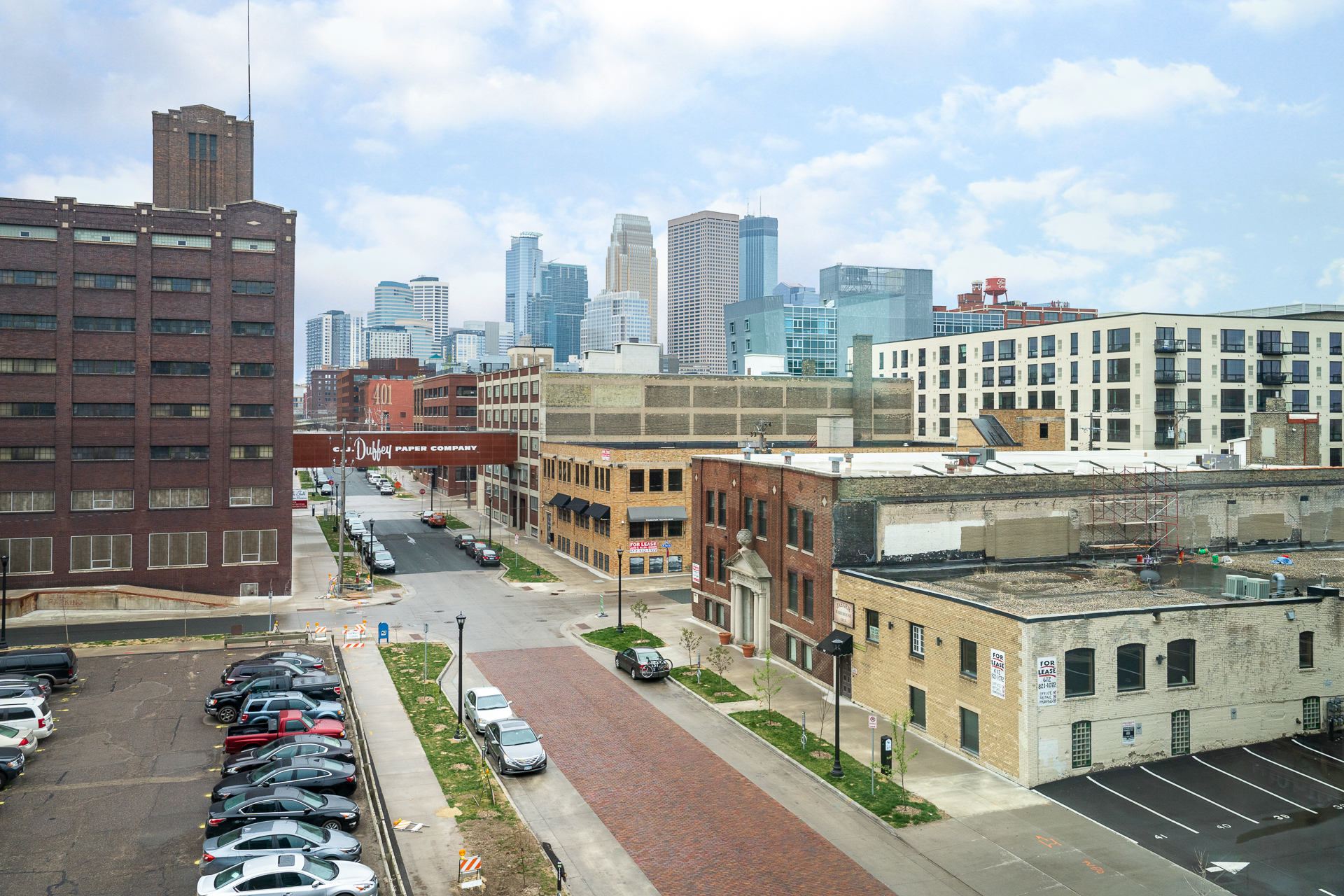 A view of a bustling urban environment with historic buildings transitioning into modern skyscrapers.