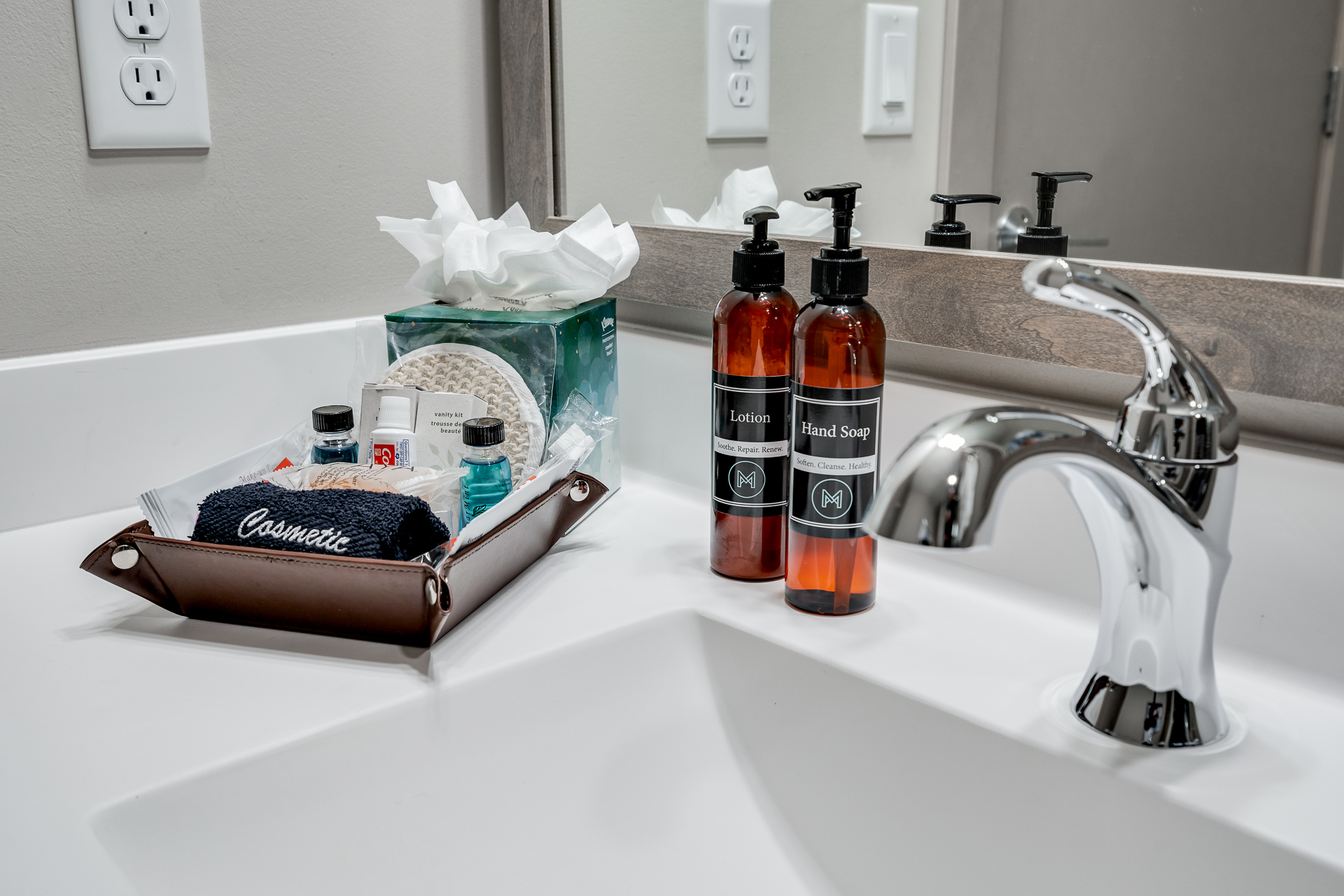 A neatly organized bathroom countertop with personal care items.