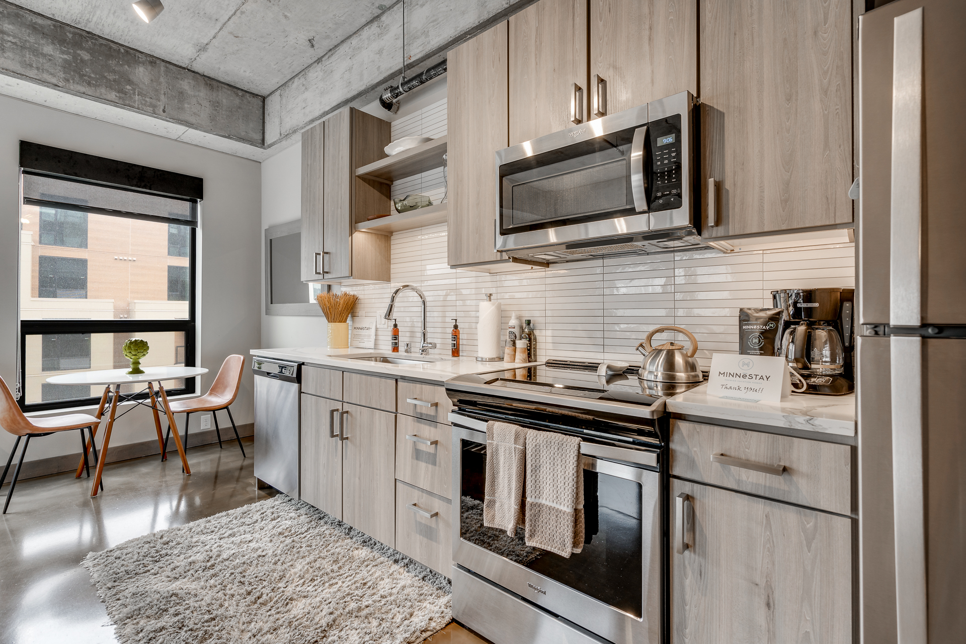 A modern kitchen with sleek design and cozy dining area.