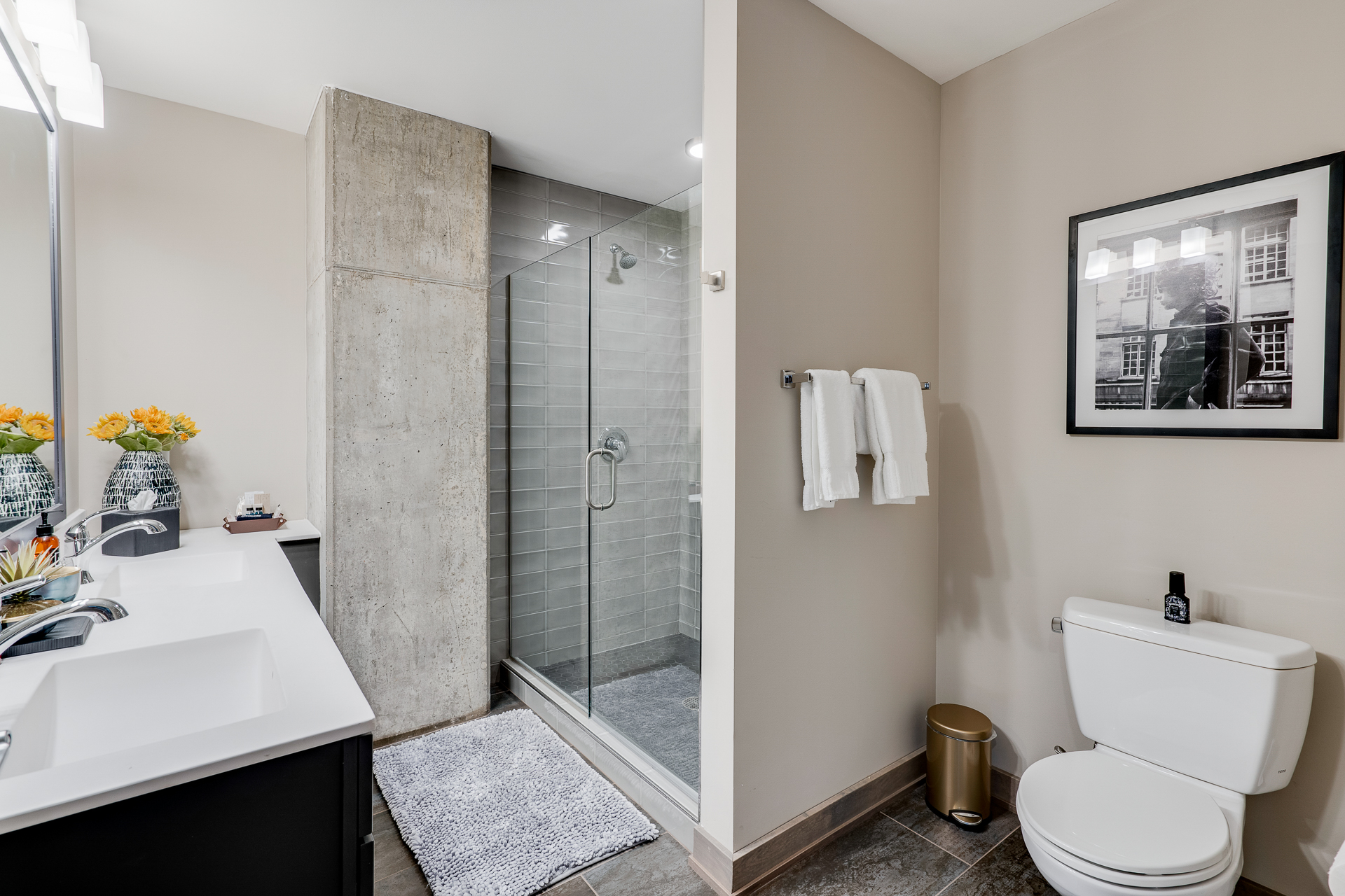 A modern bathroom featuring a sleek double vanity and a glass shower enclosure.