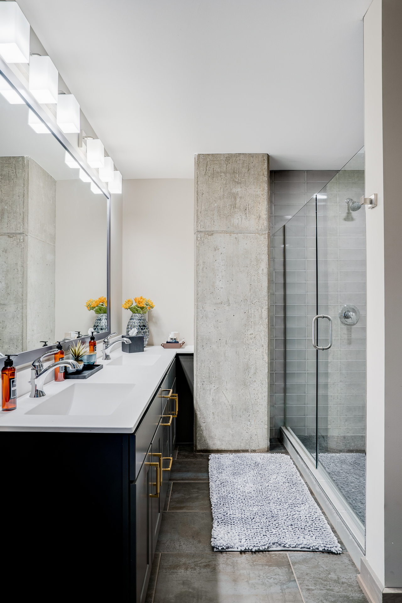 Modern bathroom featuring sleek design elements and a touch of warmth from flowers.
