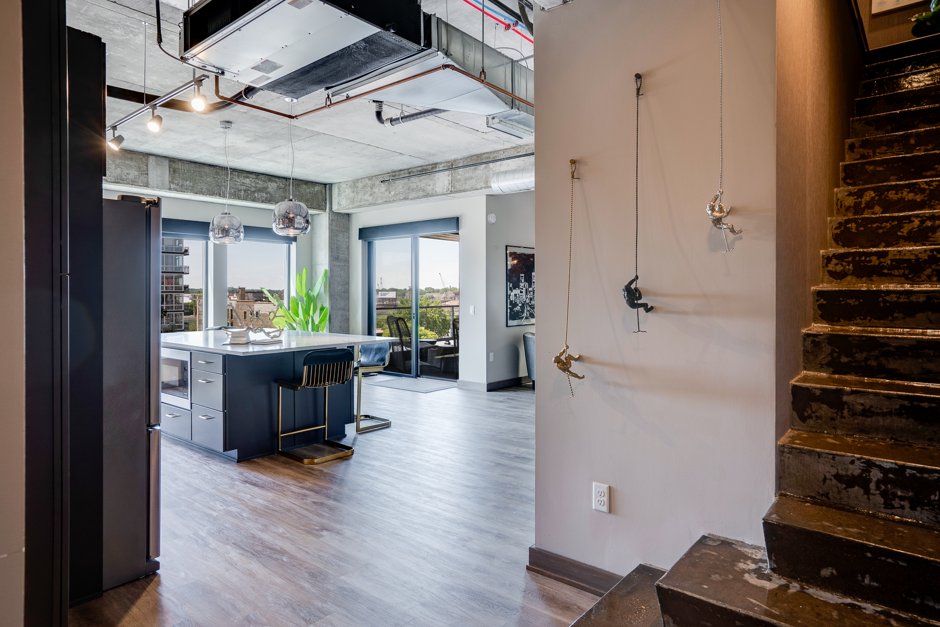 Modern loft featuring a sleek kitchen and artistic décor.