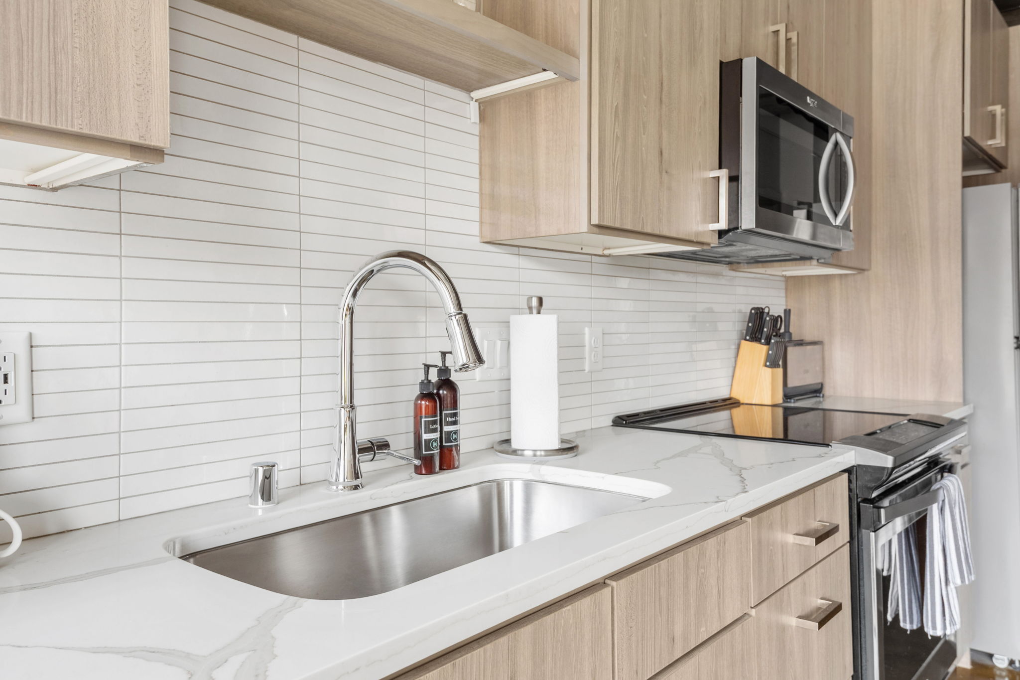 A modern kitchen featuring sleek cabinetry and a stylish stainless steel sink.