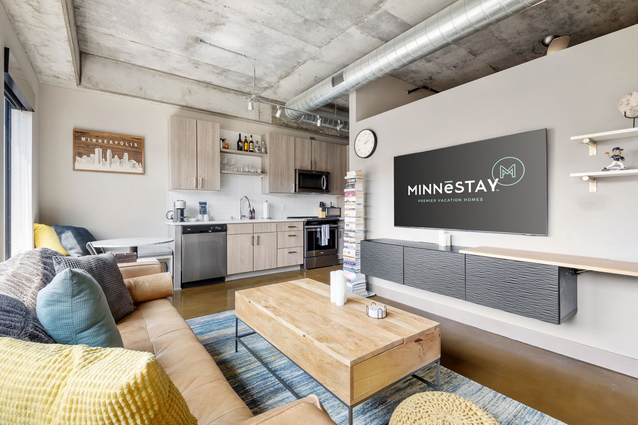 Interior view of a modern apartment living space with kitchen and cozy seating.