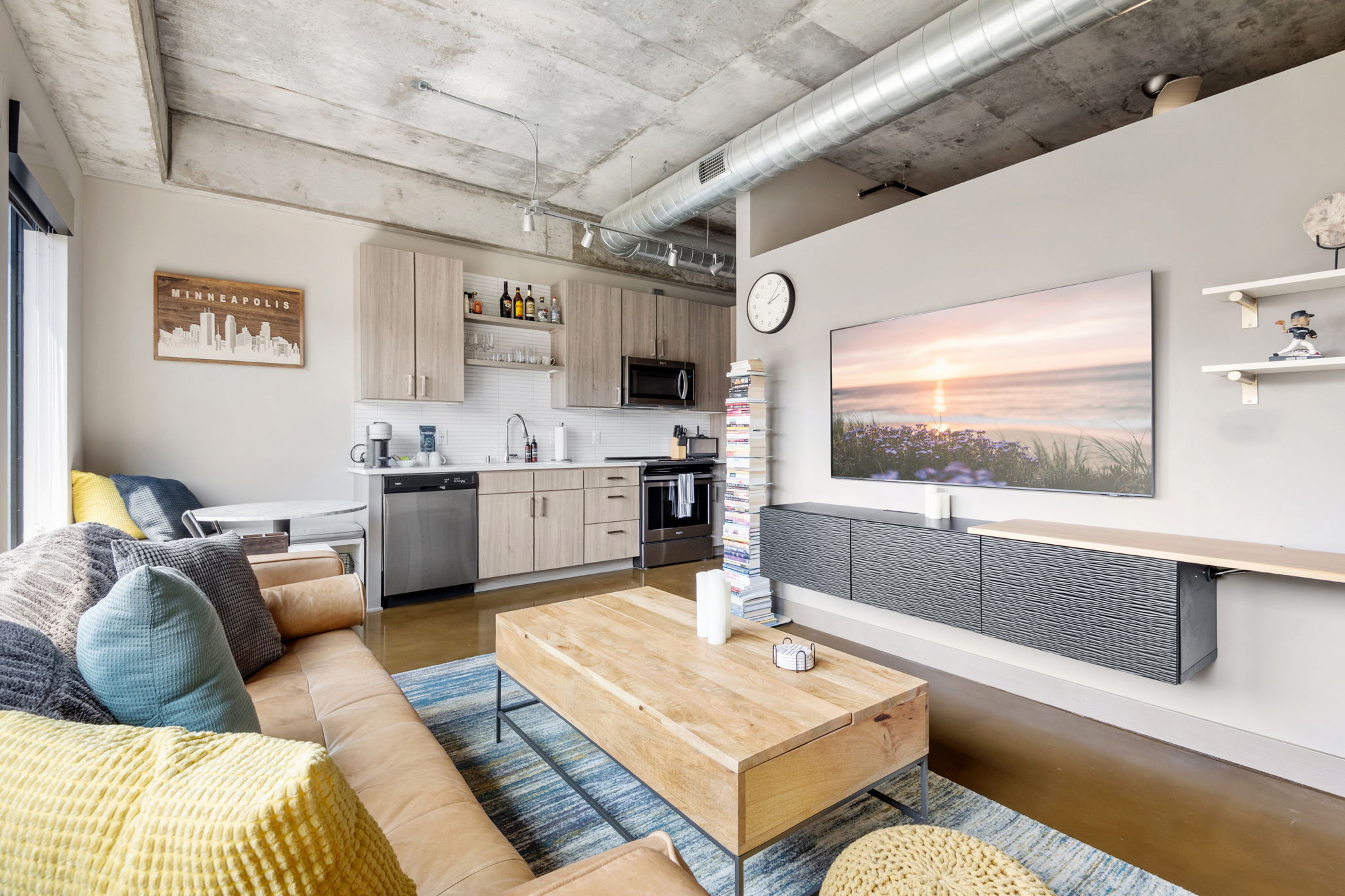 A modern and stylish living space showcasing a combination of industrial design and cozy decor elements.