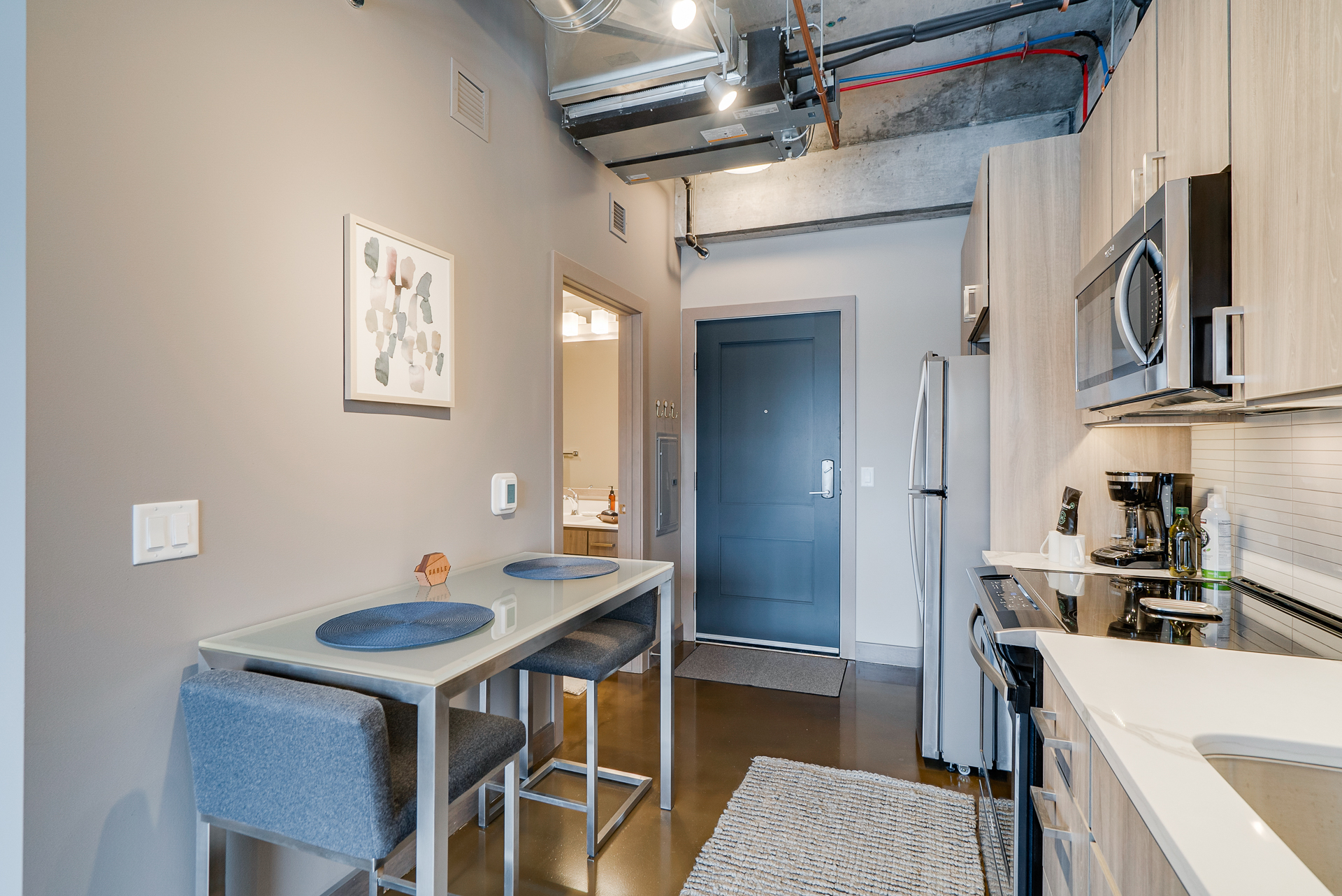 A modern kitchen area with stylish decor and appliances.